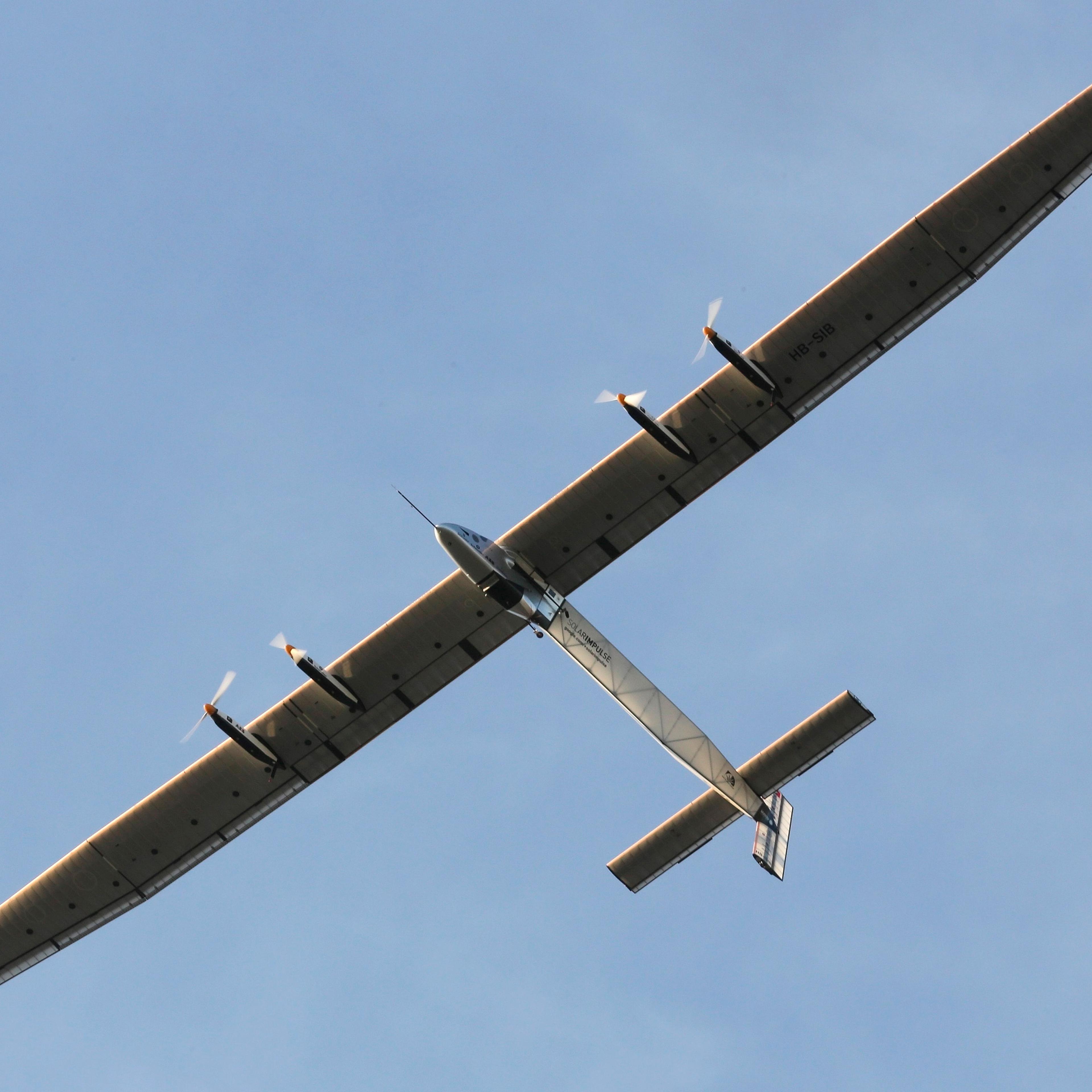 The "Solar Impulse 2", a solar powered plane, is seen on flight after taking off at the airport in Ahmedabad