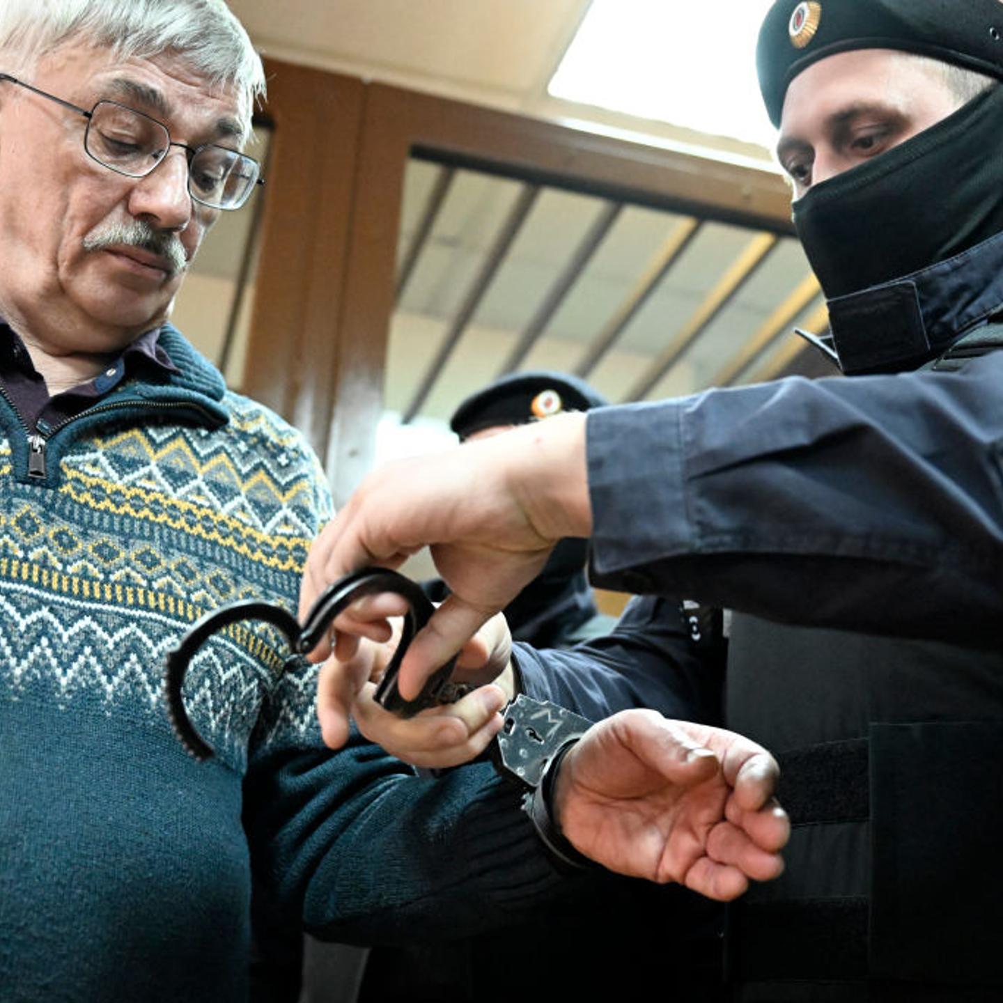 Oleg Orlov handcuffs