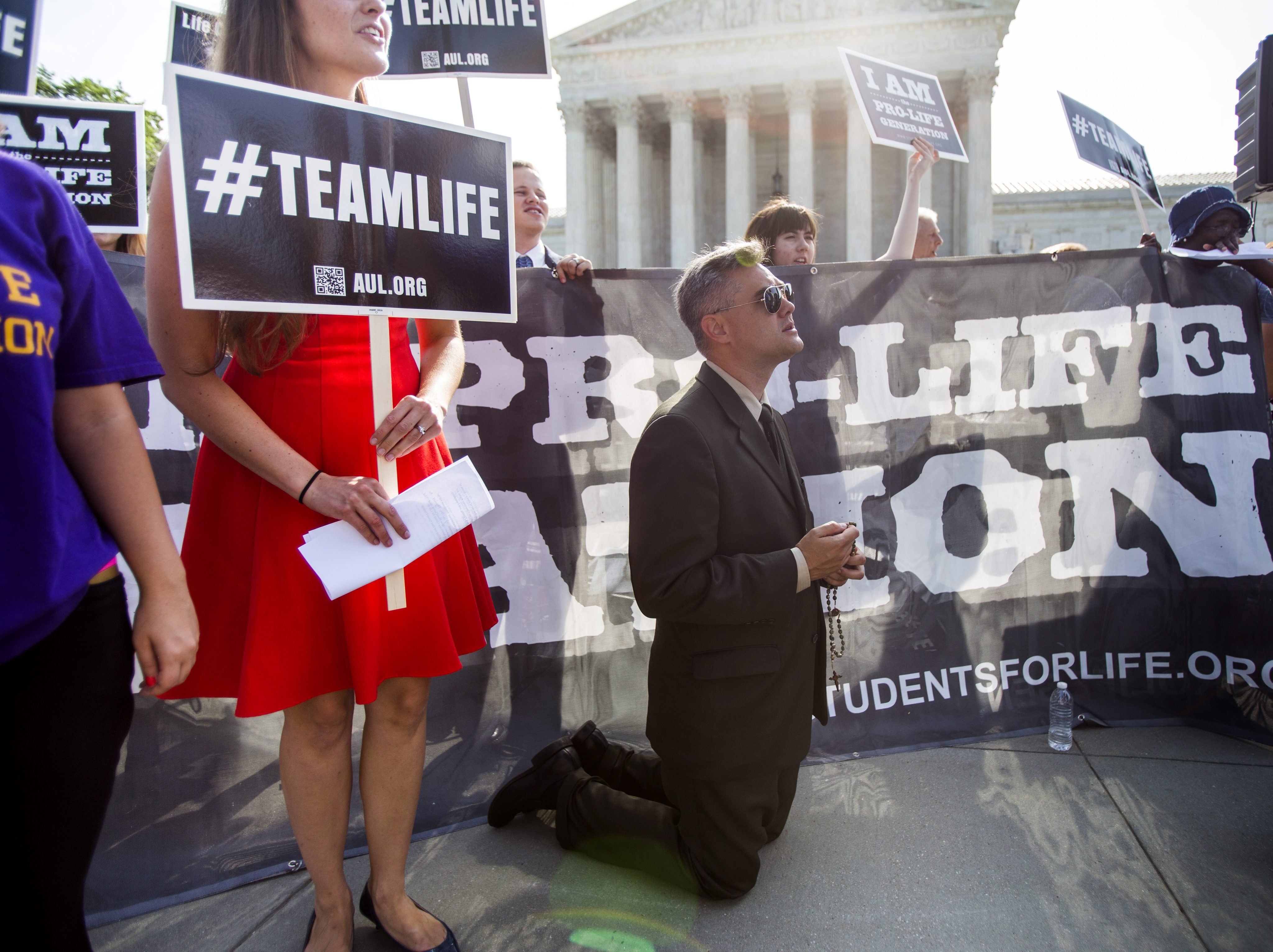 Pro-life supporter Michael Hichborn with American Life League prays outside the US Supreme Court where the nine justices are expected to issue their ruling on the Hobby Lobby case, which challenges the Affordable Care ActÕs mandate that employee health p