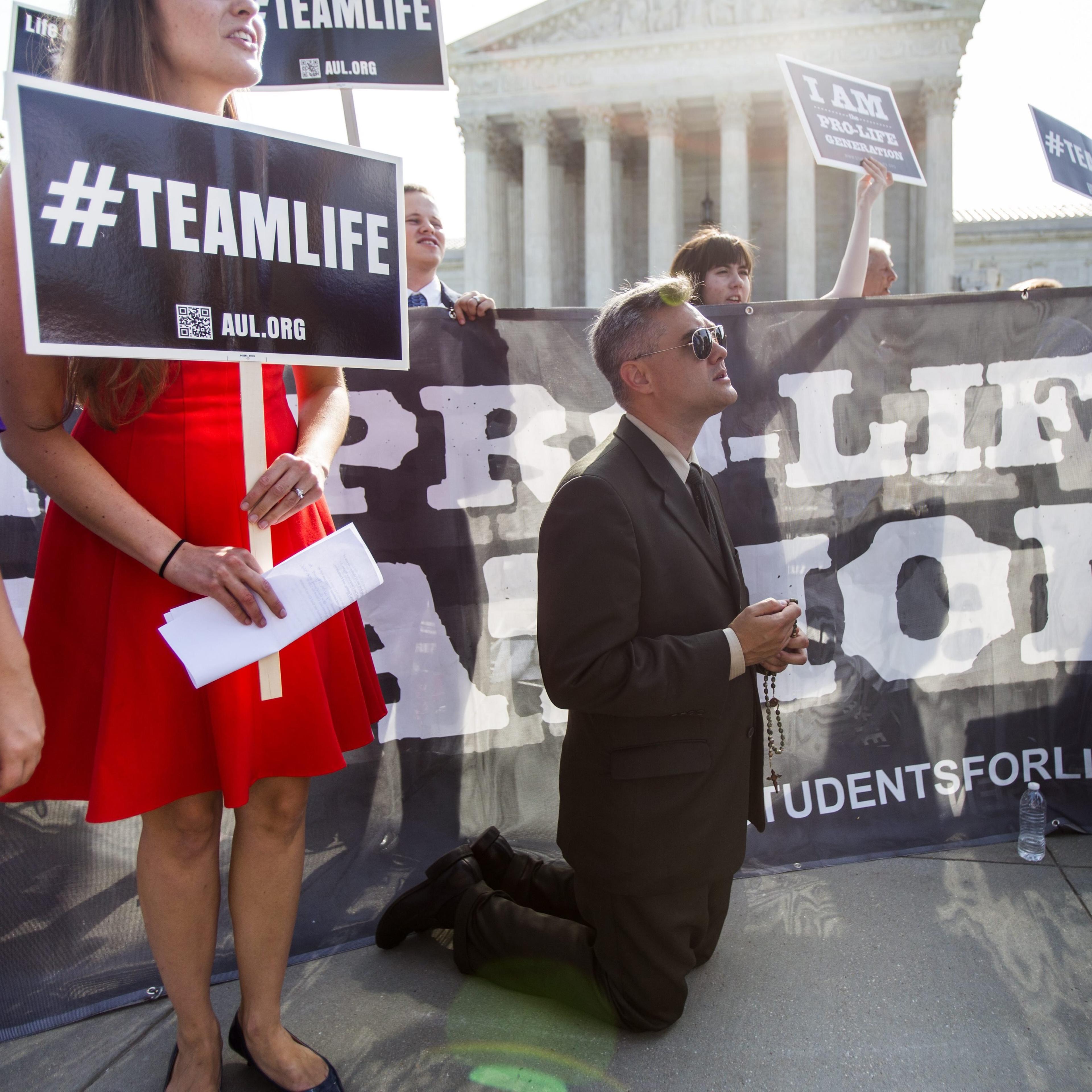 Pro-life supporter Michael Hichborn with American Life League prays outside the US Supreme Court where the nine justices are expected to issue their ruling on the Hobby Lobby case, which challenges the Affordable Care ActÕs mandate that employee health p