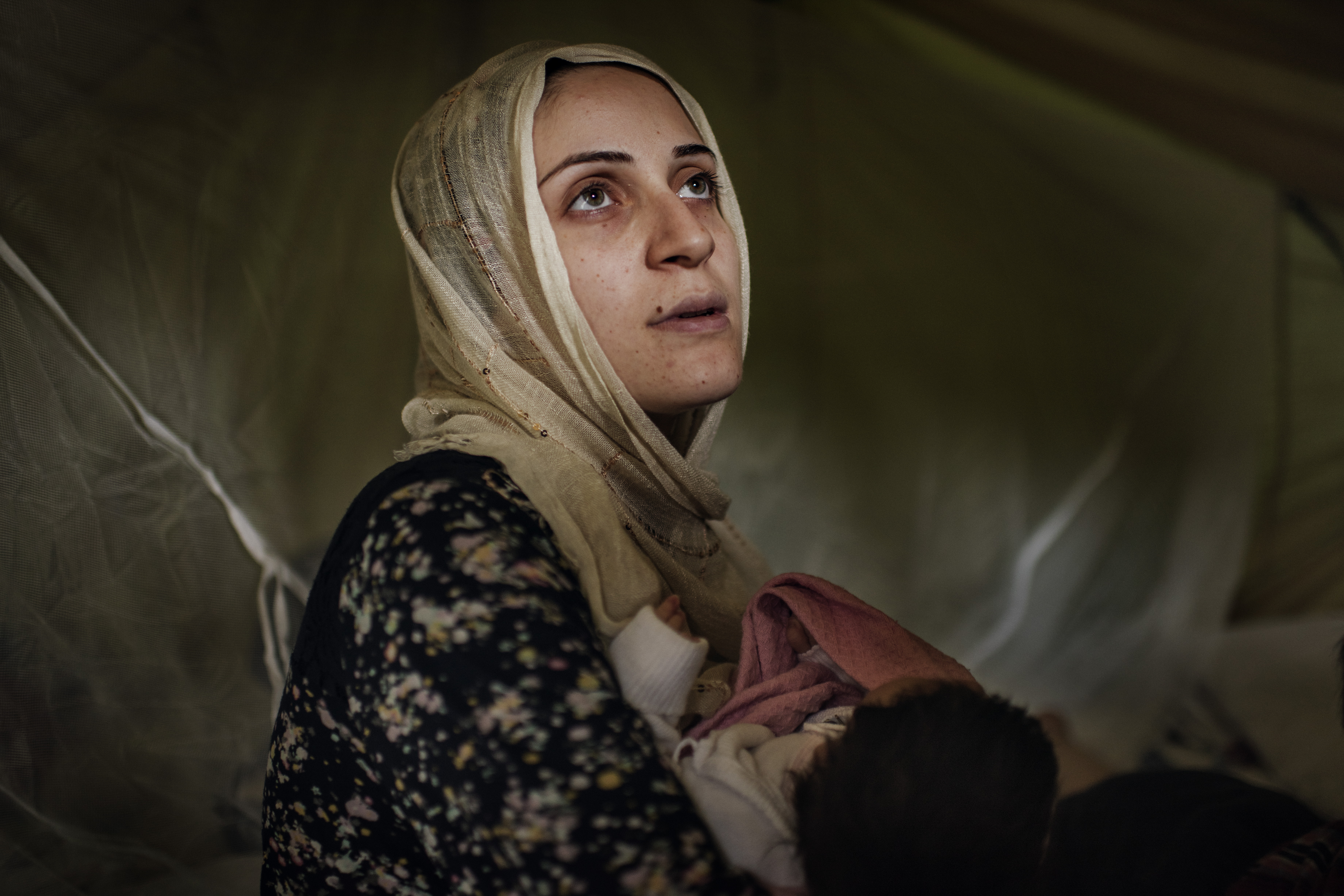 Taimma Abazli, 24, holds her new baby Heln in their tent at the Karamalis camp in Thessaloniki, Greece, September 2016.