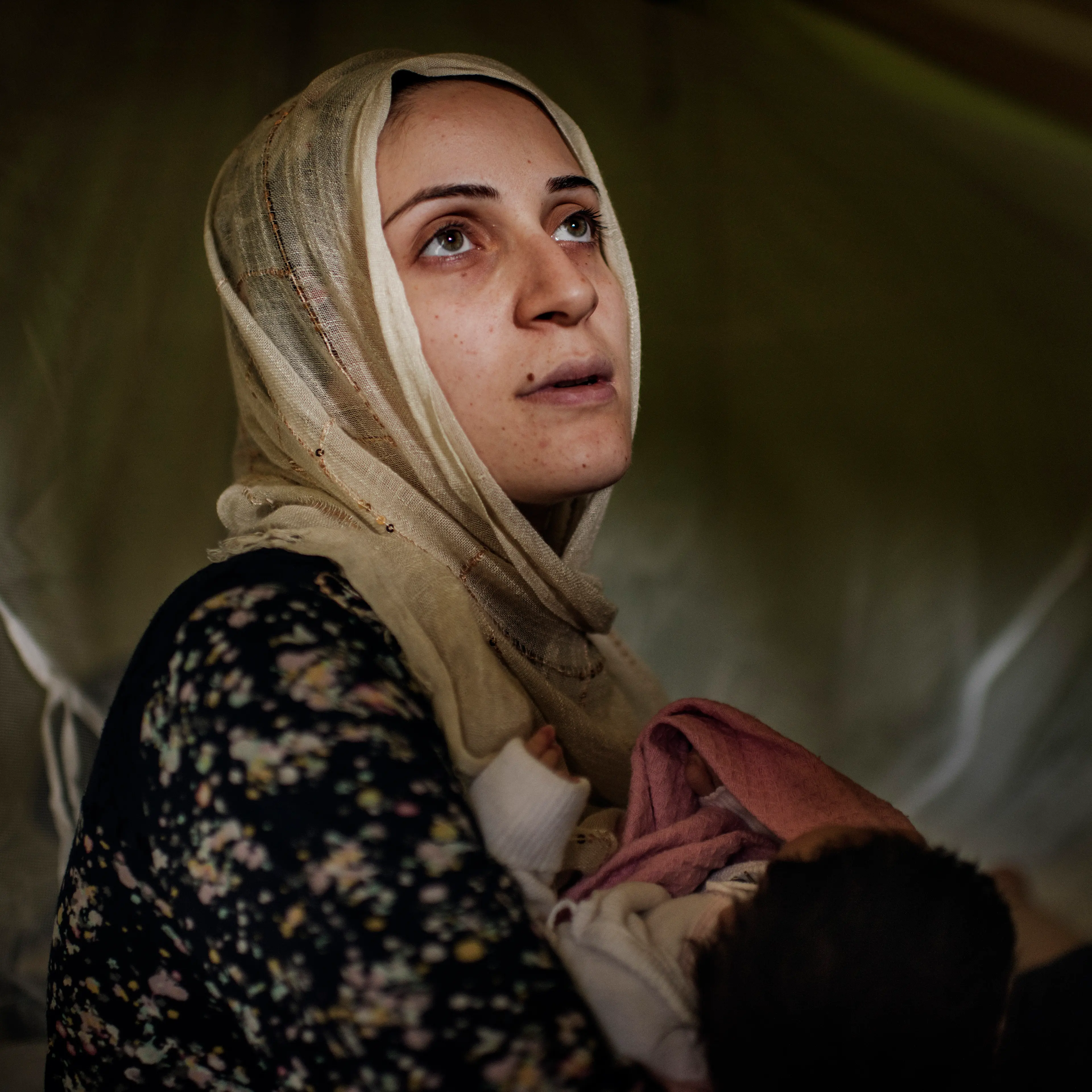 Taimma Abazli, 24, holds her new baby Heln in their tent at the Karamalis camp in Thessaloniki, Greece, September 2016.
