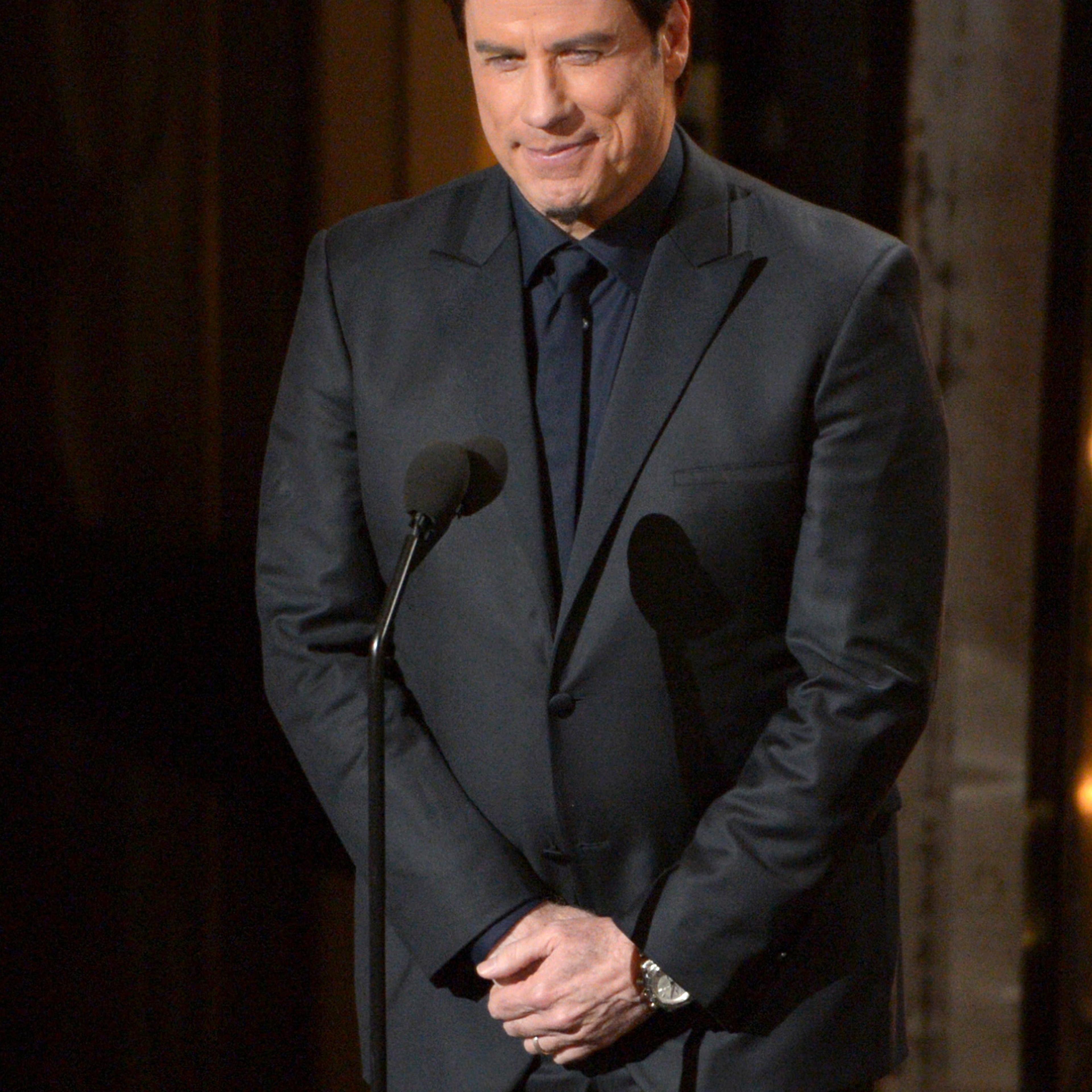 Presenter John Travolta speaks during the Oscars at the Dolby Theatre on Sunday, March 2, 2014, in Los Angeles.
