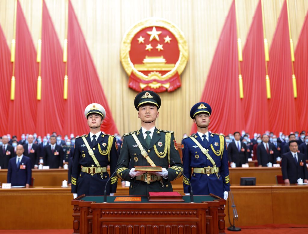 The guard of honor of the Chinese People's Liberation Army PLA carry a copy of the country's Constitution during the ceremony for newly elected Chinese leaders to pledge allegiance to the Constitution at the Great Hall of the People in Beijing, capital o