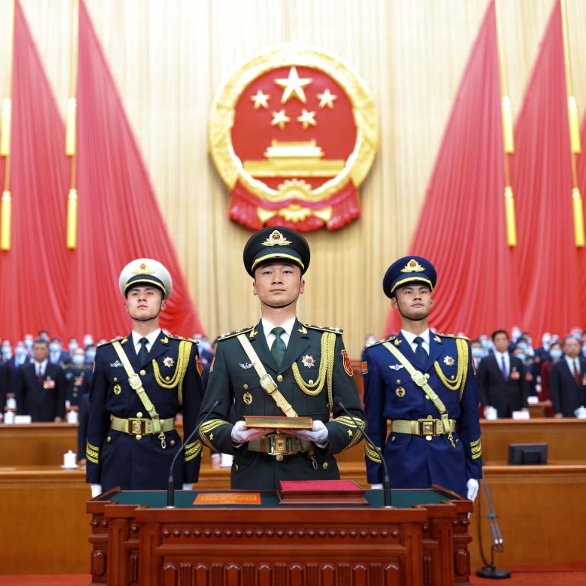 The guard of honor of the Chinese People's Liberation Army PLA carry a copy of the country's Constitution during the ceremony for newly elected Chinese leaders to pledge allegiance to the Constitution at the Great Hall of the People in Beijing, capital o