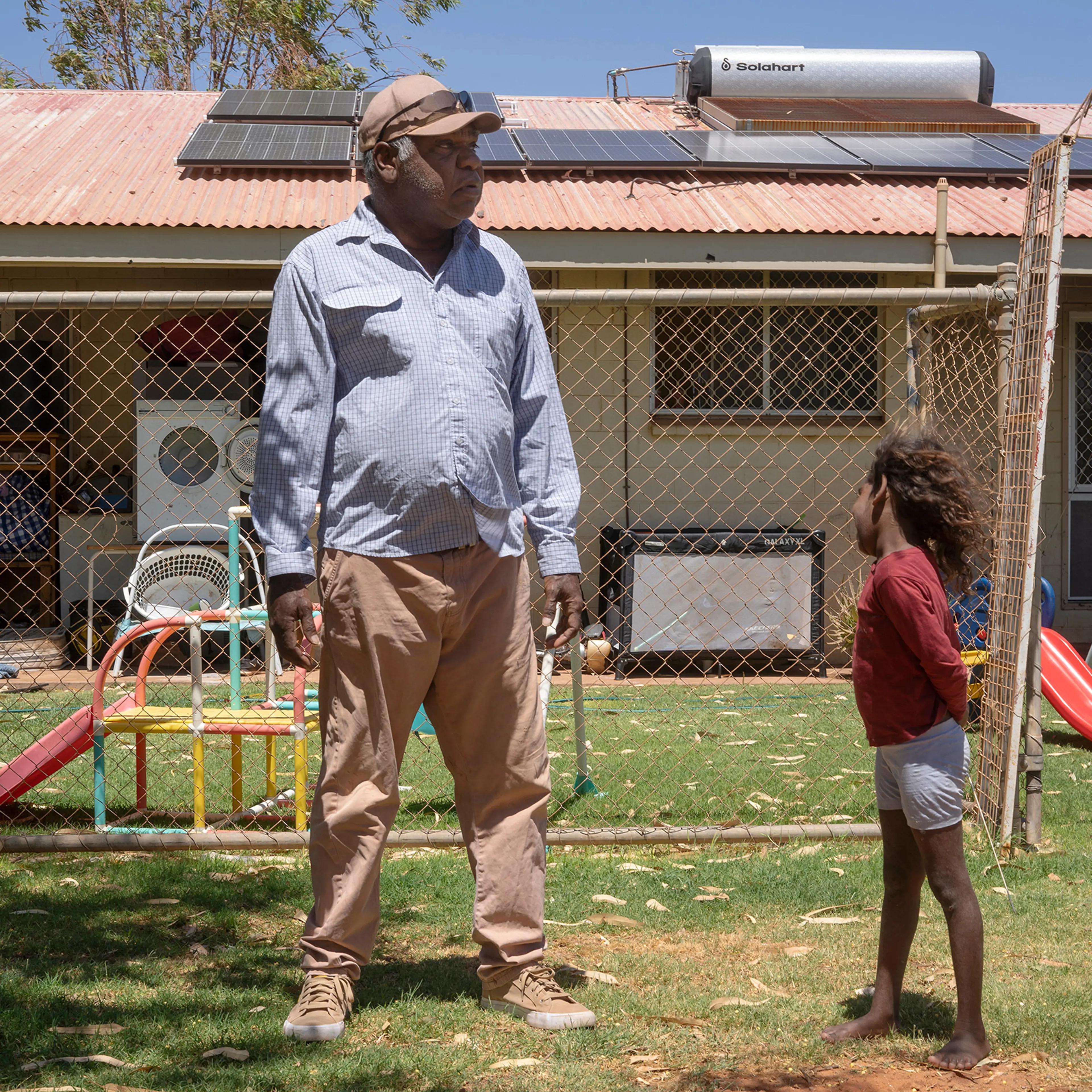 Frank in front of his Tennant Creek home. His local energy provider isn’t able to connect the solar panels on his roof to the grid, making them functionally useless
