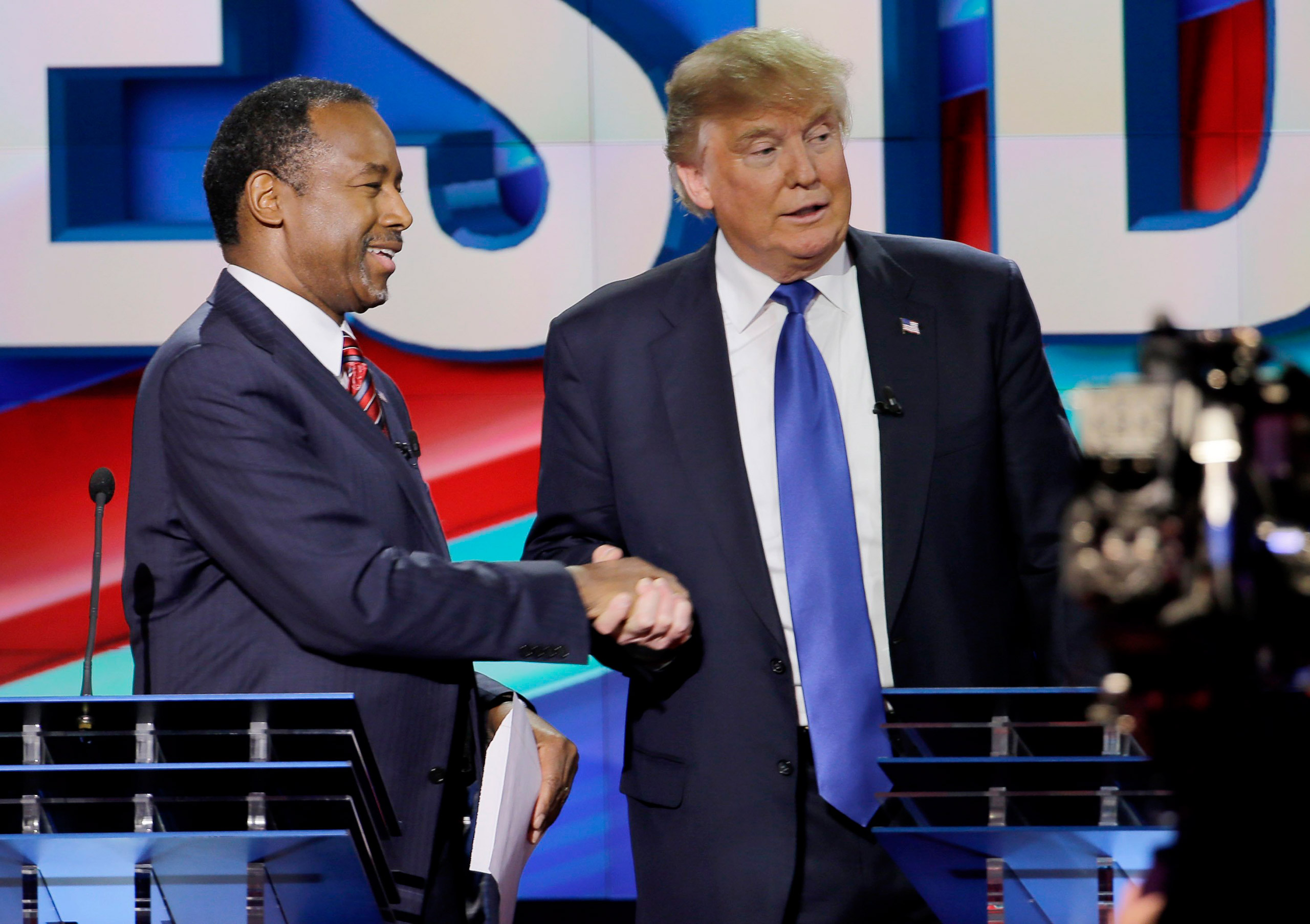 Republican presidential candidate Ben Carson shakes hands with Donald Trump after a Republican presidential primary debate at the University of Houston, Feb. 25, 2016.