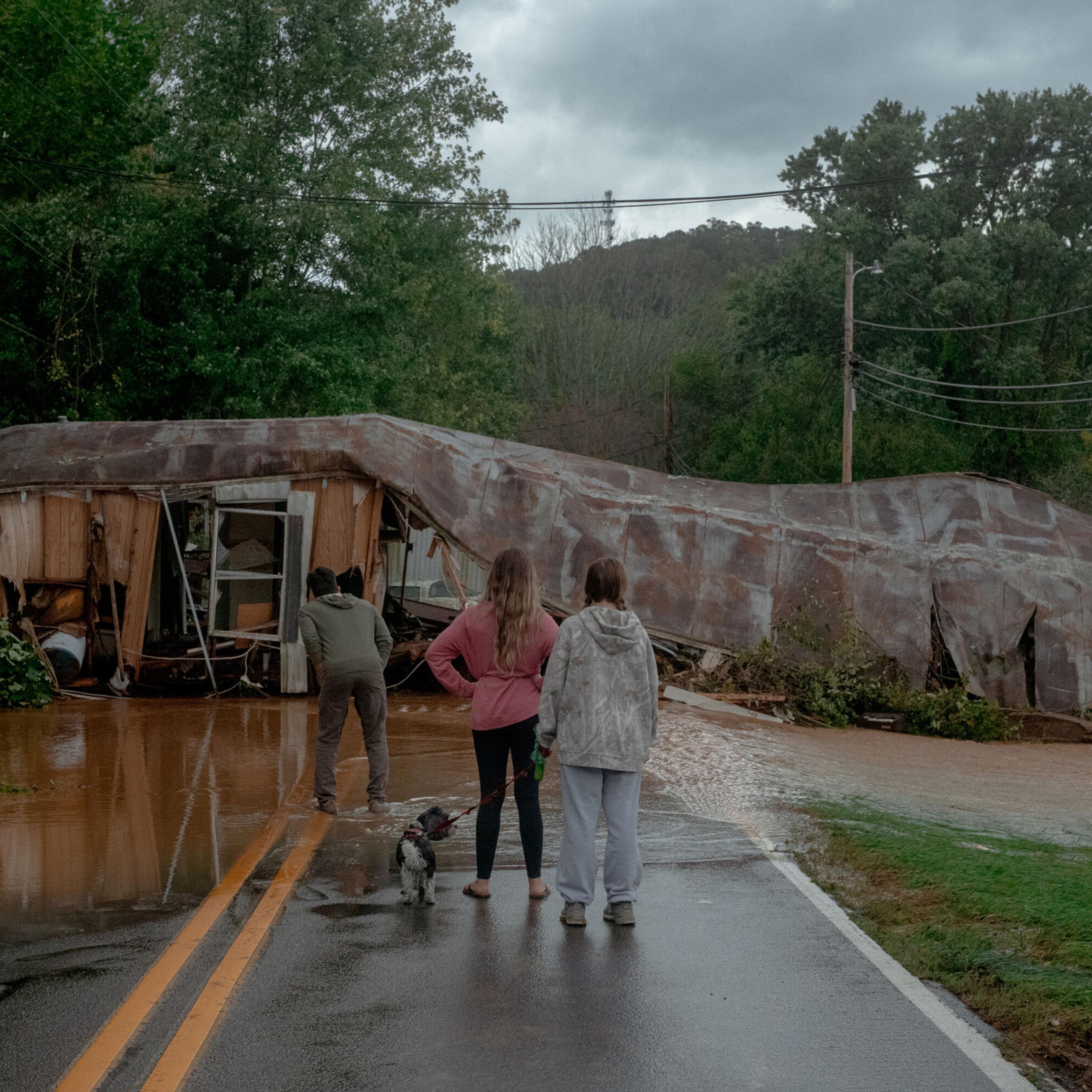 Floodwaters and a destroyed building block a road in Swannanoa, N.C., Sept. 27, 2024. (Mike Belleme/The New York Times)