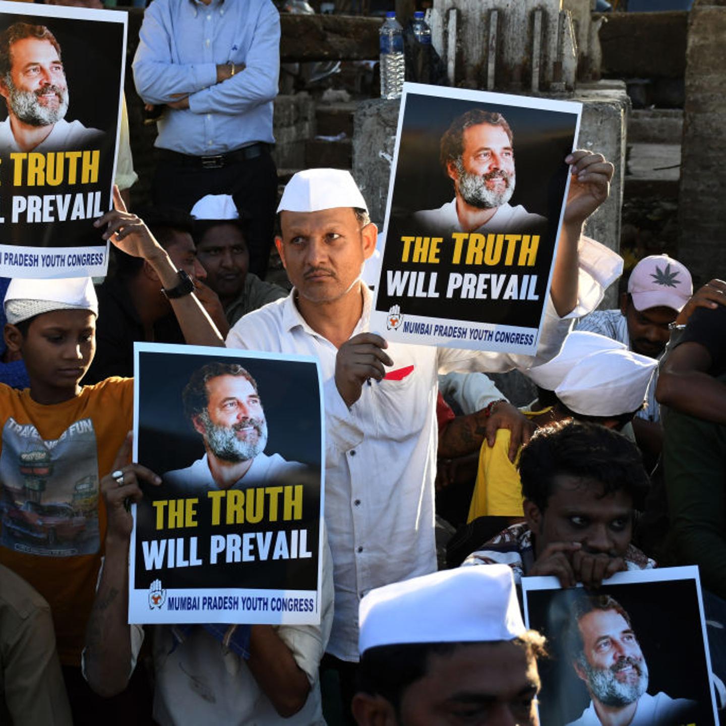 Congress supporters hold placards with a picture of the