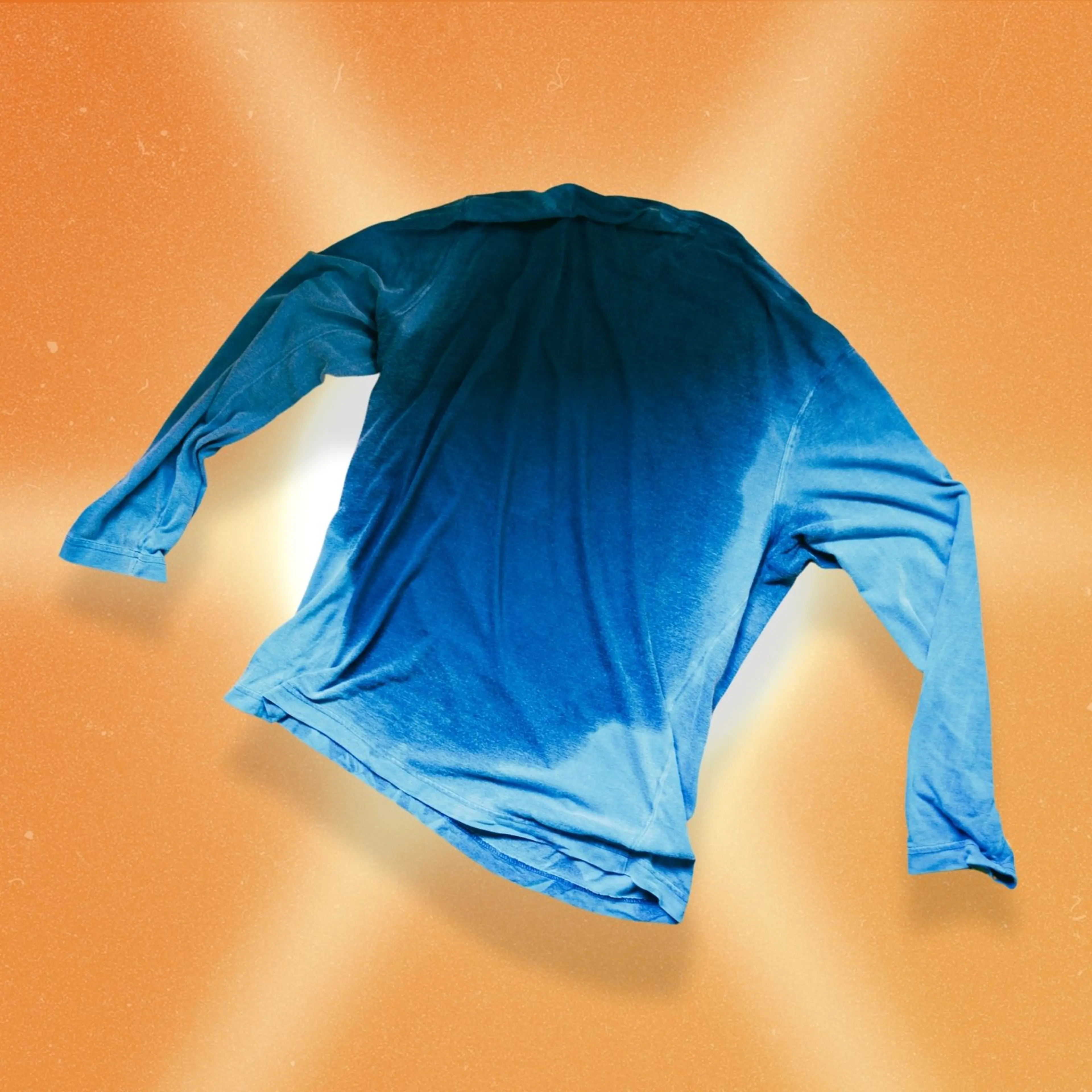 A blue long sleeve shirt with a big sweat spot on it