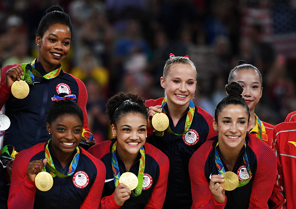 Gold Medalists Gabrielle Douglas, Simone Biles, Lauren Hernandez, Madison Kocian and Alexandra Raisman of the United States pose for photographs on the podium at the medal ceremony for the Artistic Gymnastics Women's Team on Day 4 of the Rio 2016 Olympic
