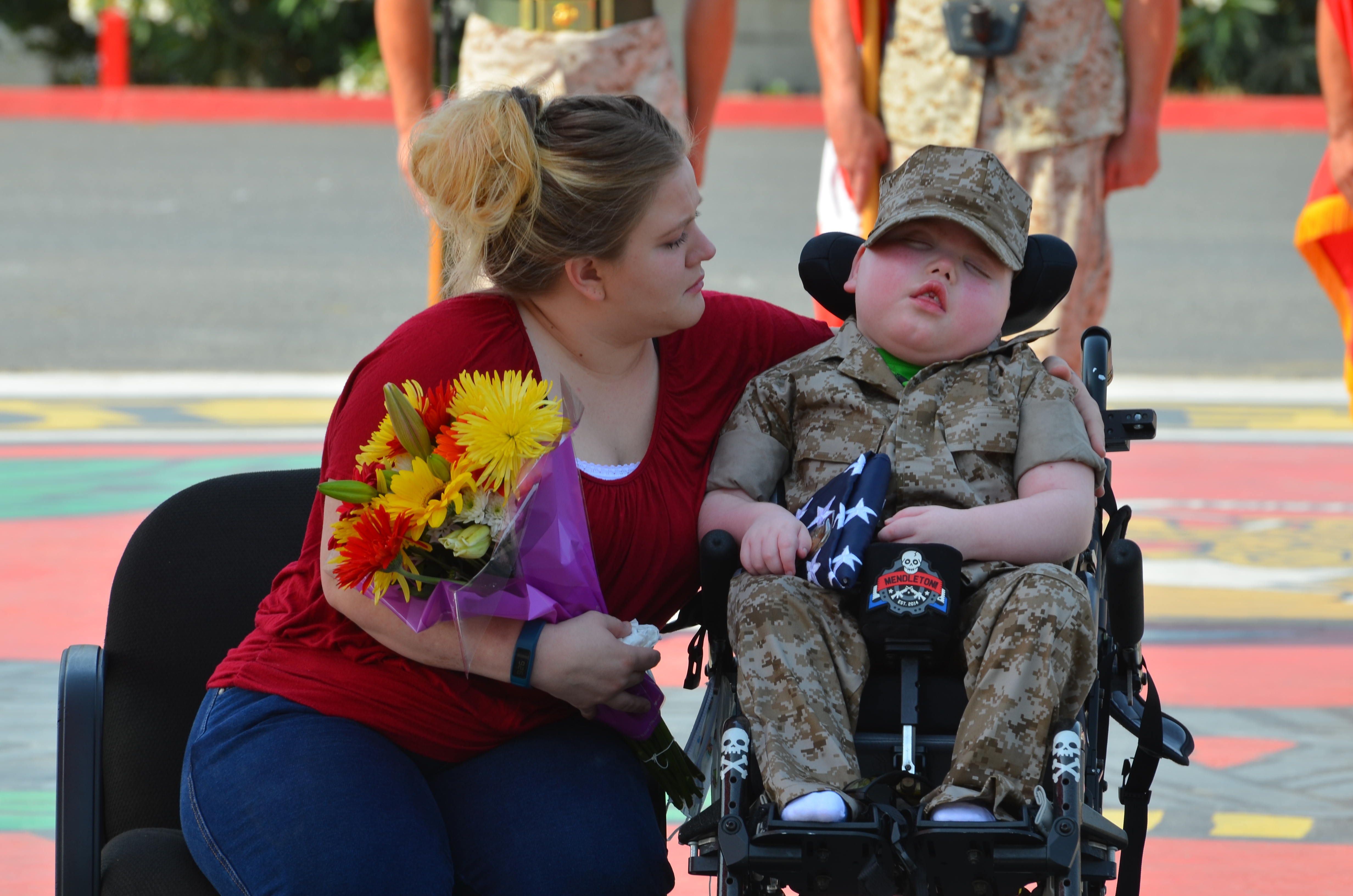 Wyatt Gillette is named an honorary Marine while his mother, Felishia Gillette, sits beside him at a ceremony at the Marine Corps Base Camp in Pendleton, Calif., on July 30.