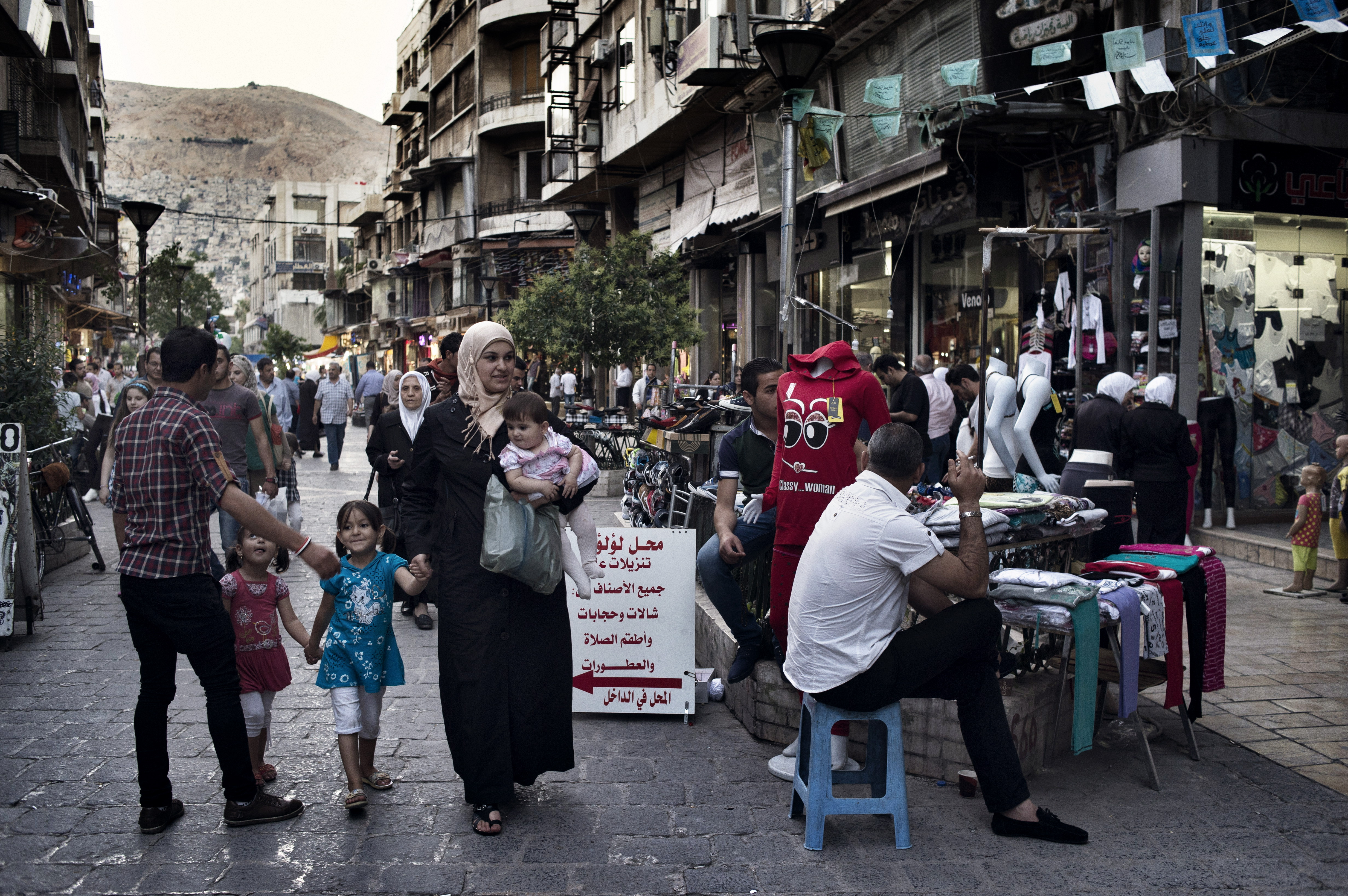 A family walks down a street in Damascus on May 14, 2014.