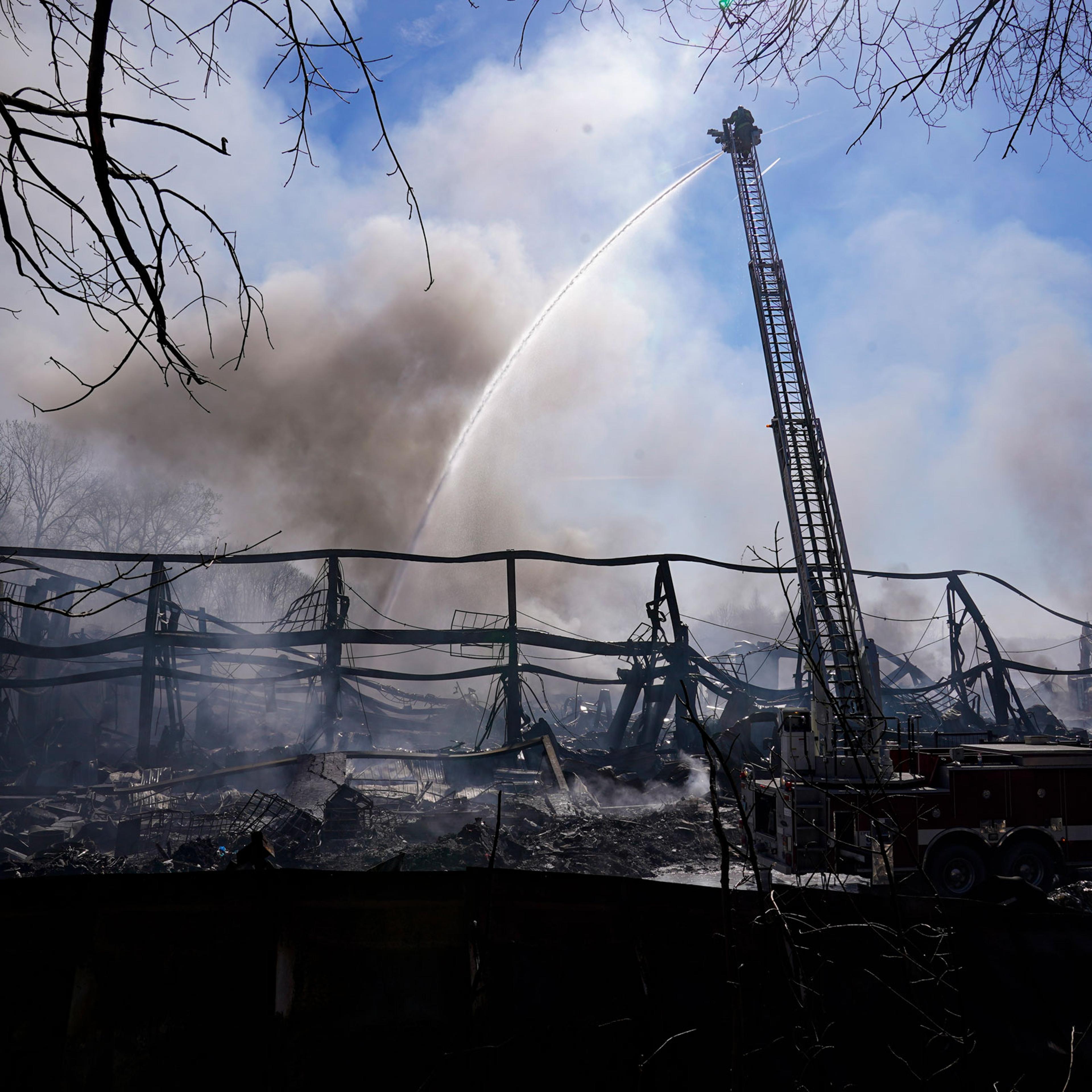 Firefighters pour water on an industrial fire in Richmond, Ind., on April 13, 2023.