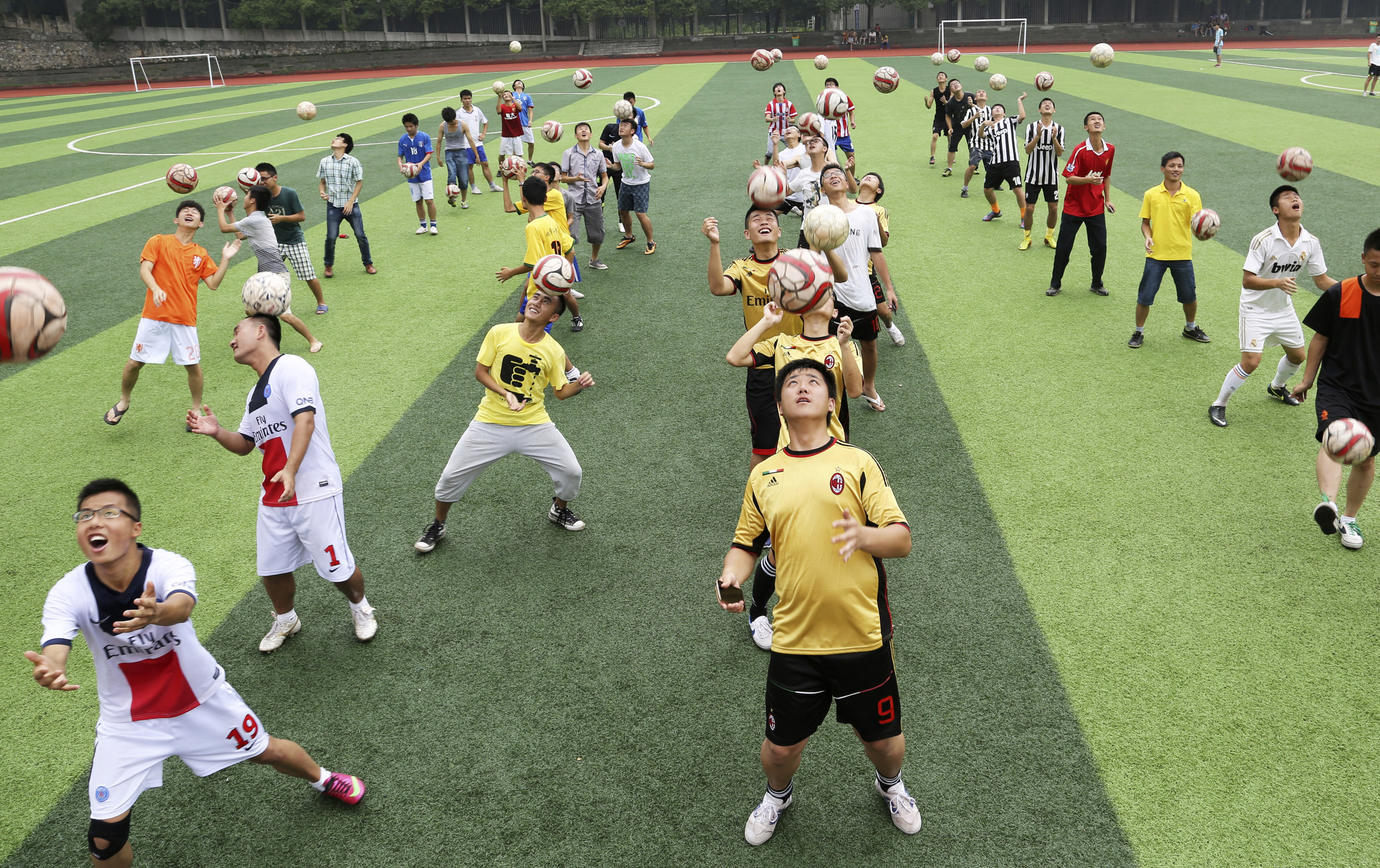 Students head soccer balls during a competition at the campus of University of South China in Hengyang, Hunan province