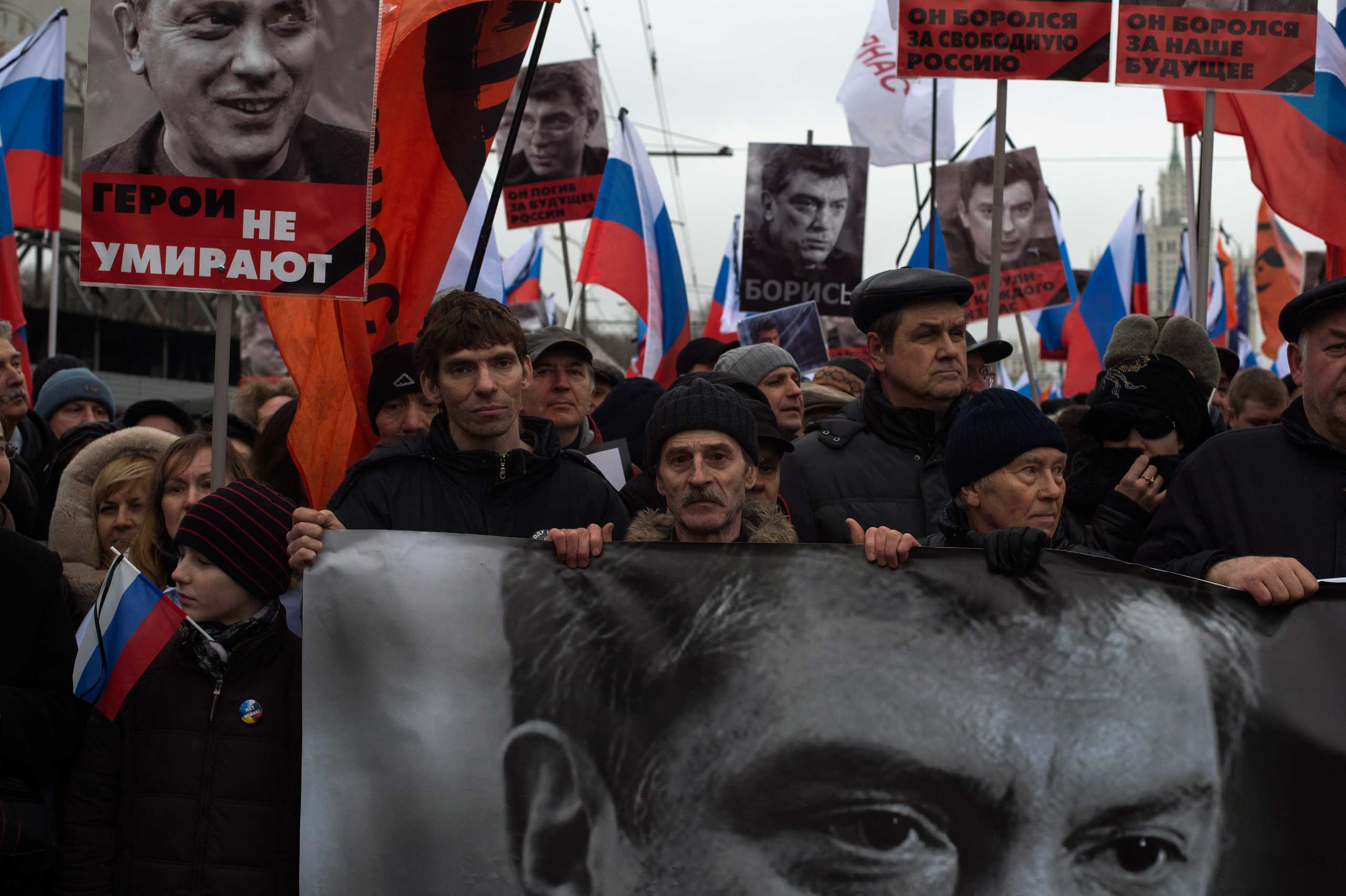 Moscow, Russia, Sunday, March 1, 2015. People carry a huge banner reading 'those bullets for everyone of us, heroes never die!' as they march in memory of opposition leader Boris Nemtsov who was gunned down on Friday, Feb. 27, 2015 near the Kremlin.Thous