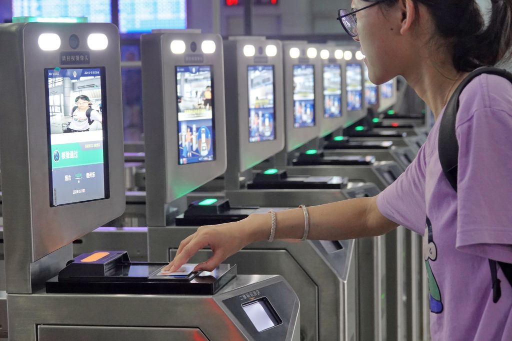 Passengers are using their ID cards to get to the station at Yantai Station in Yantai, China, on July 1, 2024.