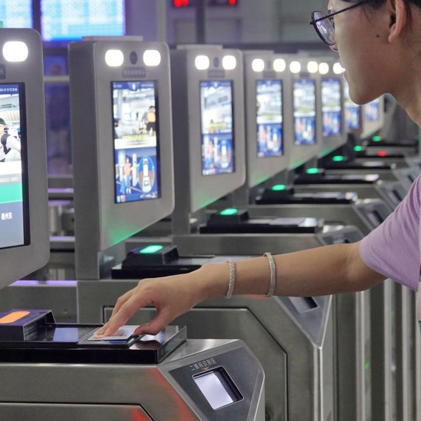 Passengers are using their ID cards to get to the station at Yantai Station in Yantai, China, on July 1, 2024.