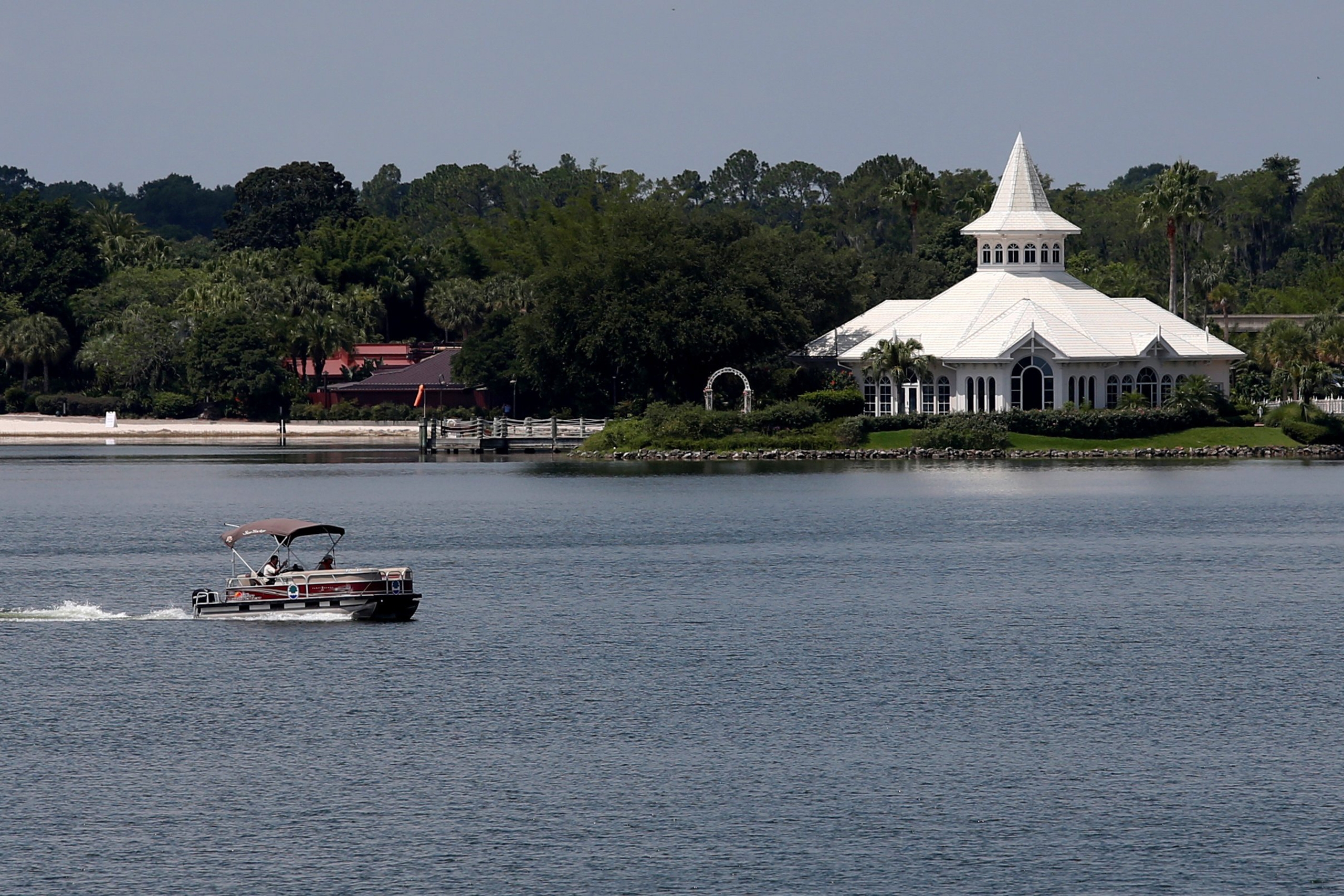 A search boat is seen passing Disney's Fairy Tale Weddings Chapel in the Seven Seas Lagoon, located near the Grand Floridian, at the Walt Disney World resort in Orlando, Florida, U.S., June 15, 2016. REUTERS/Adrees Latif TPX IMAGES OF THE DAY