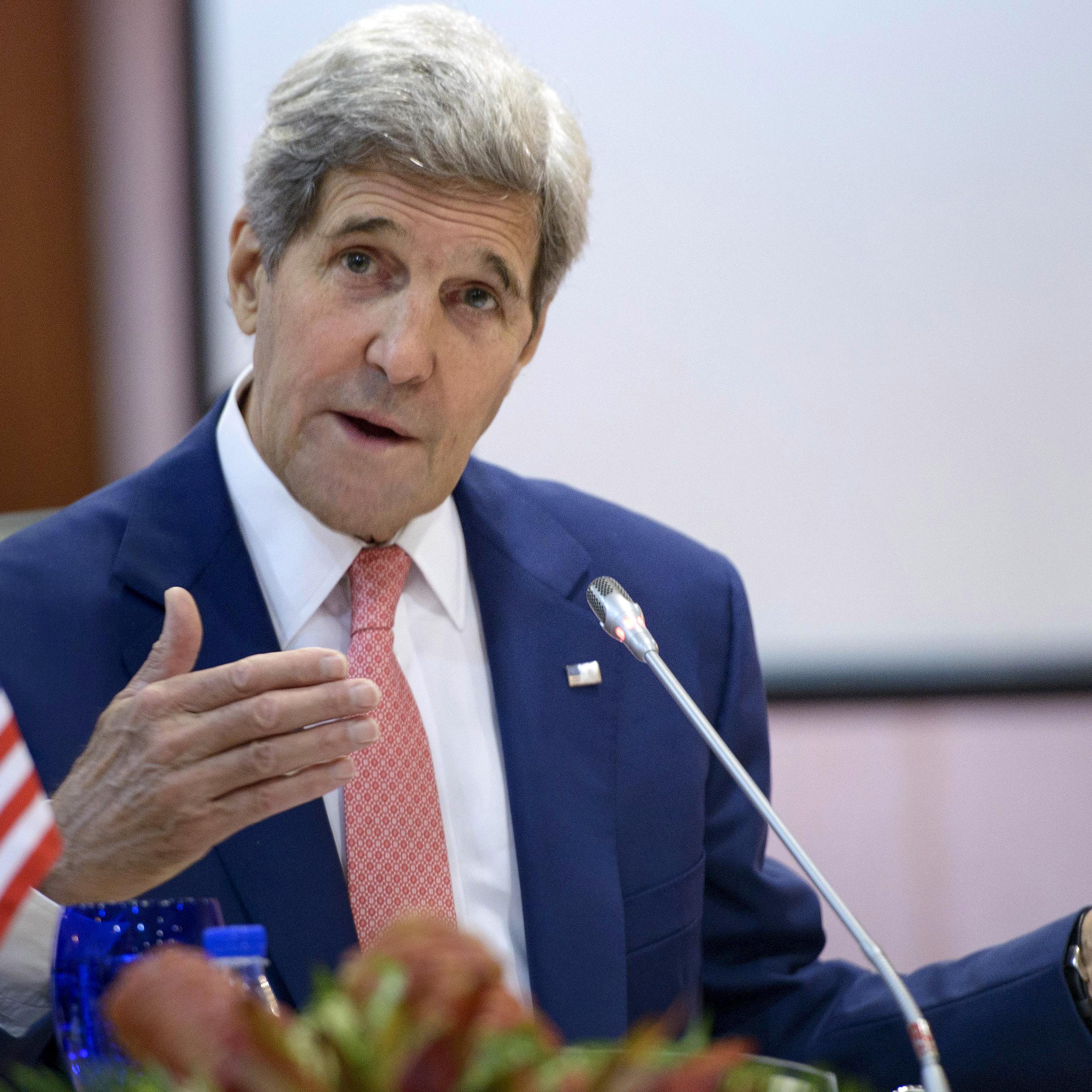 US Secretary of State John Kerry holds up Joseph Kennedy's cane, which has been used by John F. Kennedy and Ted Kennedy, while talking about his broken leg during the 8th Lower Mekong Initiative Ministerial Meeting at the Putra World Trade Center