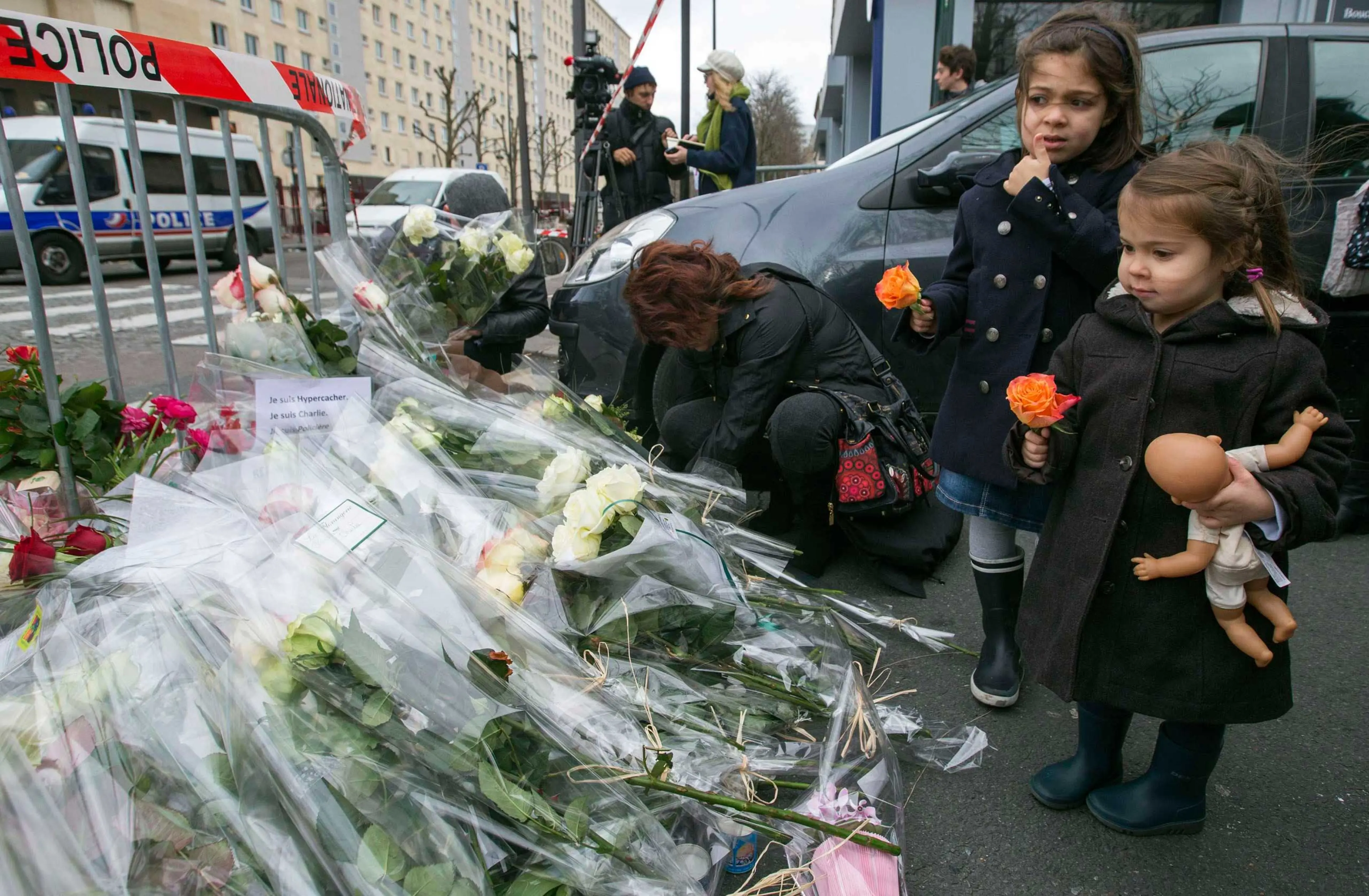 Children lay flowers outside the Hyper Cacher kosher supermarket near Porte de Vincennes in eastern Paris