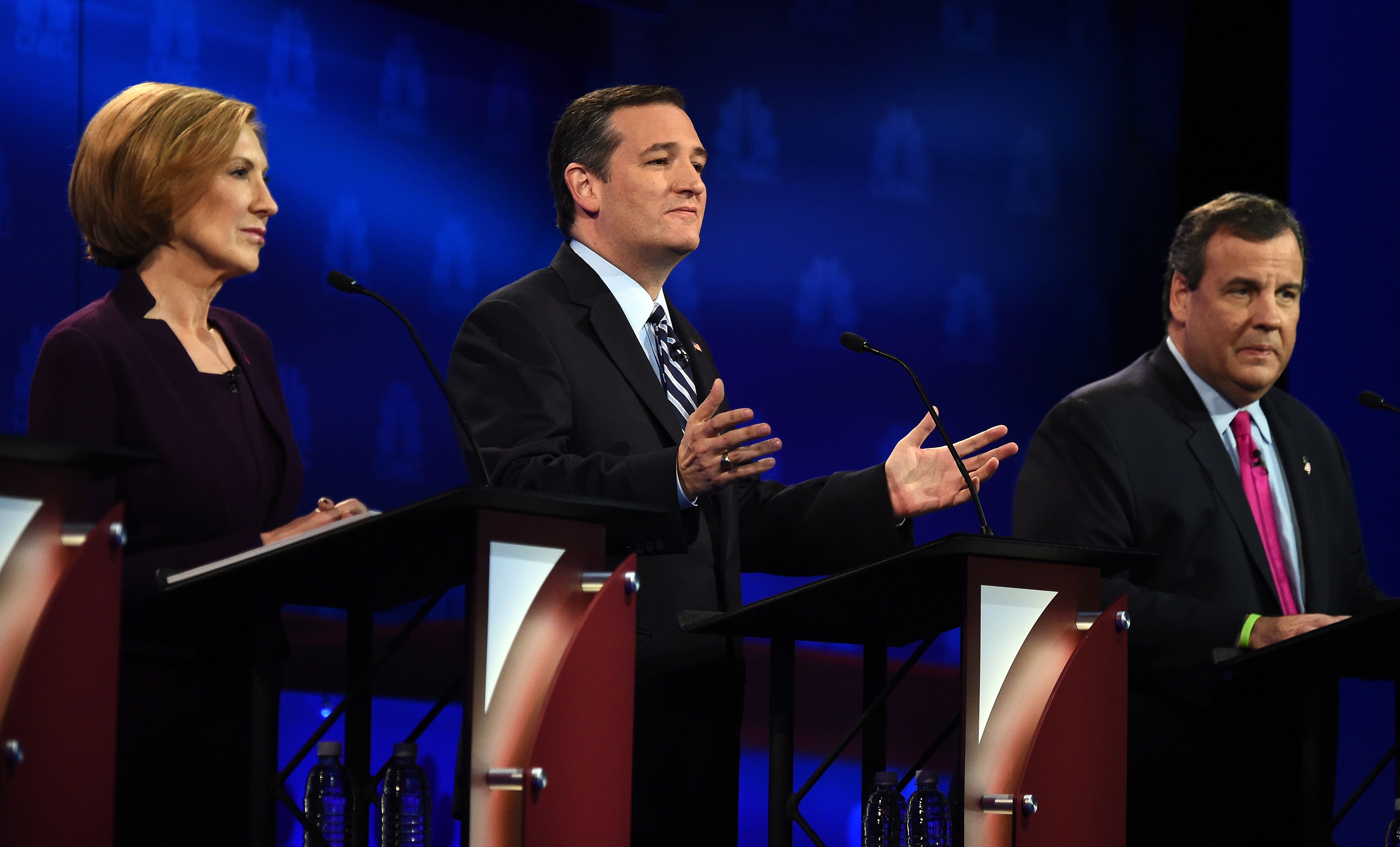 Republican Presidential hopeful Ted Cruz (C) gestures as Carly Fiorina (L) and Chris Christie look on during the CNBC Republican Presidential Debate, October 28, 2015 at the Coors Event Center at the University of Colorado in Boulder, Colo.