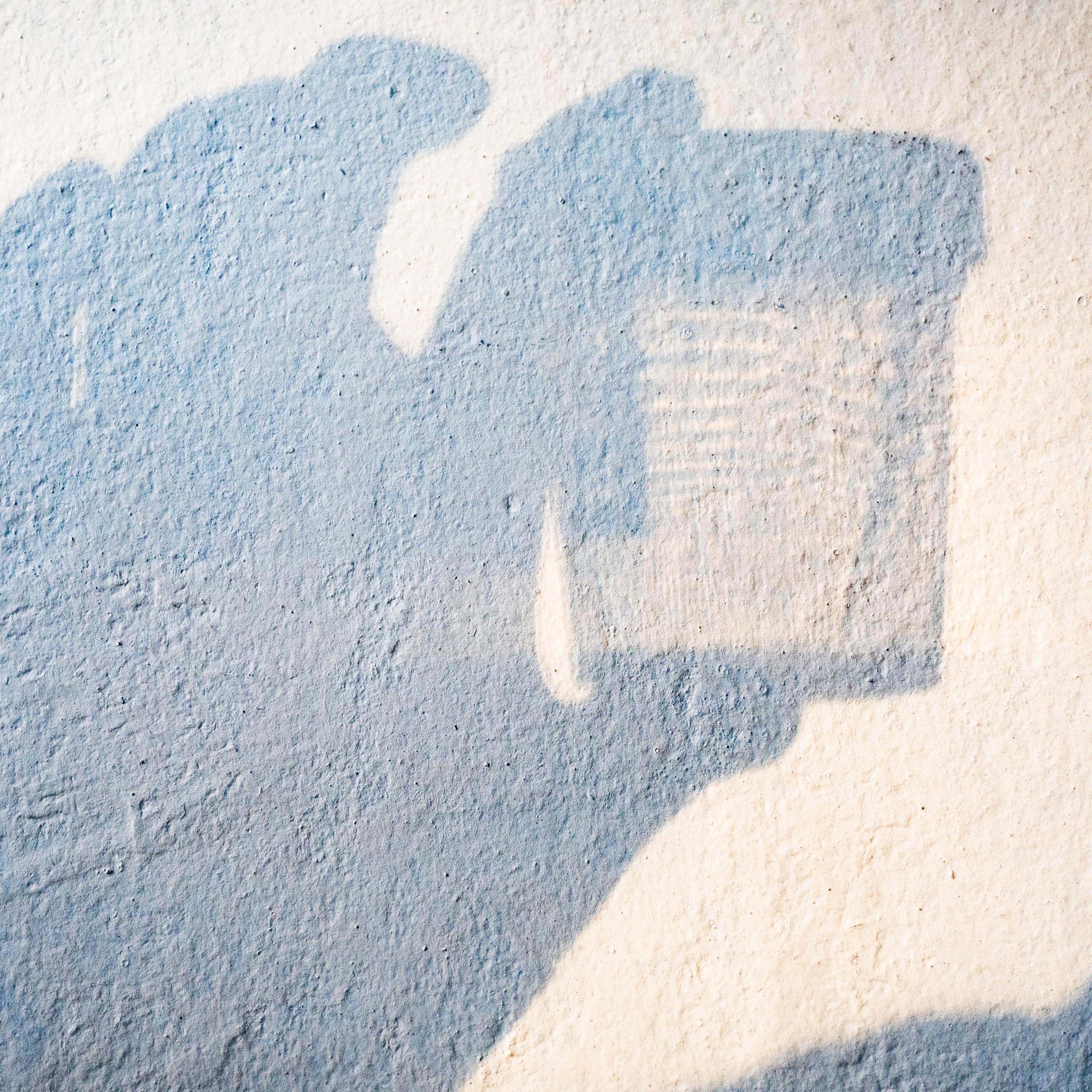 Shadow of someone holding in the hand a container to collect urine samples for laboratory analysis.