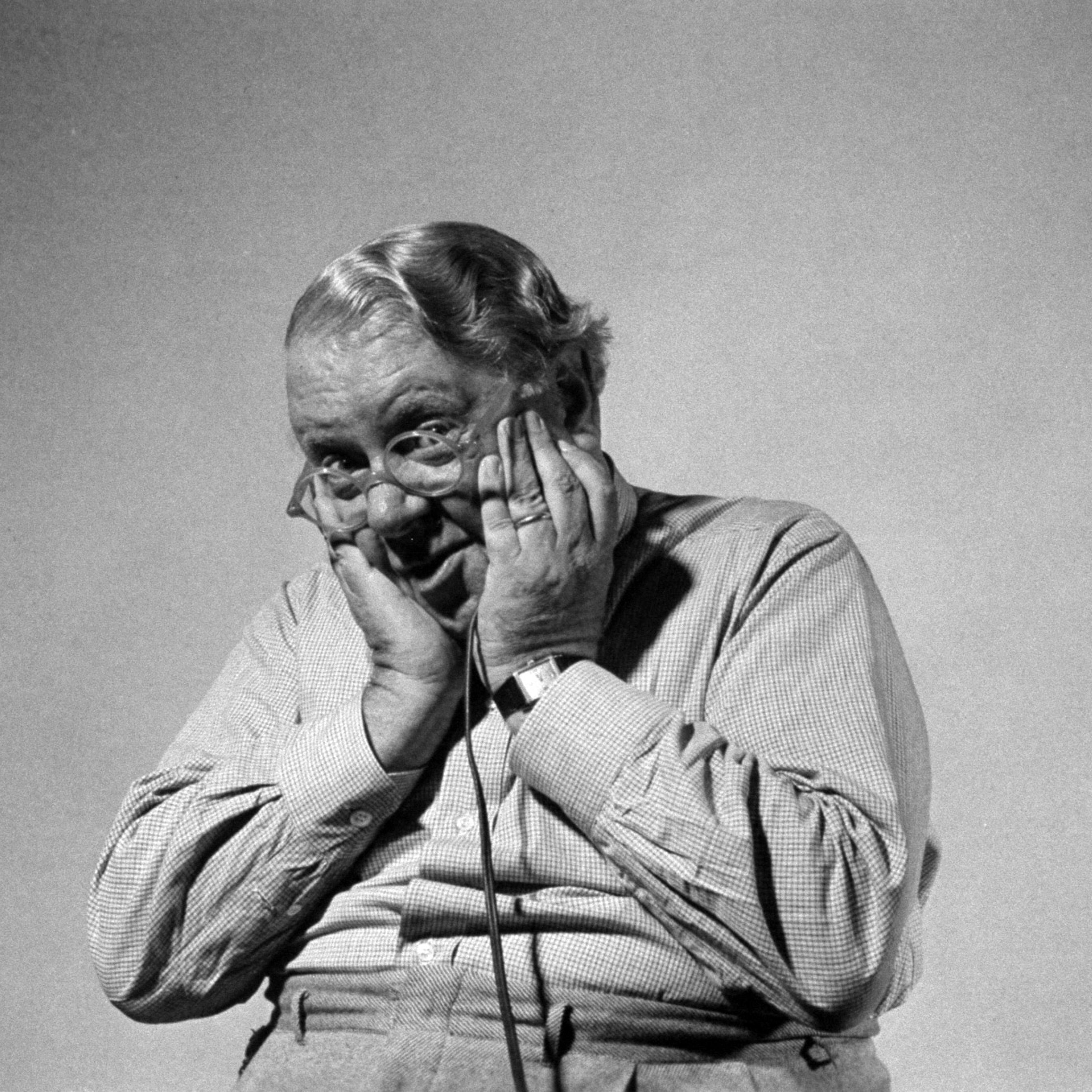 Actor S. Z. Sakall "Cuddles" holding shutter release as he takes his own photograph.