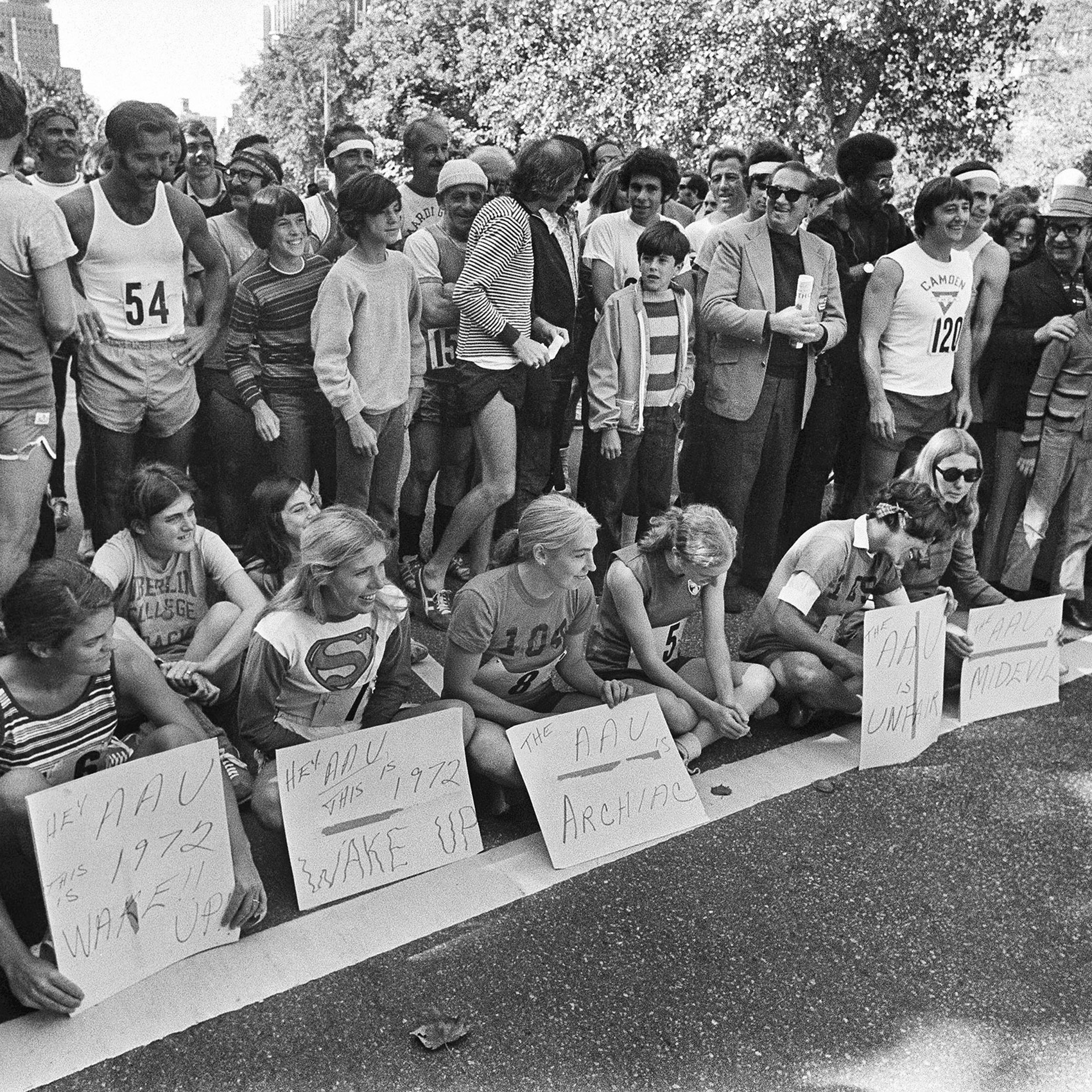 Six women officially in the New York City Marathon sit in protest at the start of the marathon in New York.