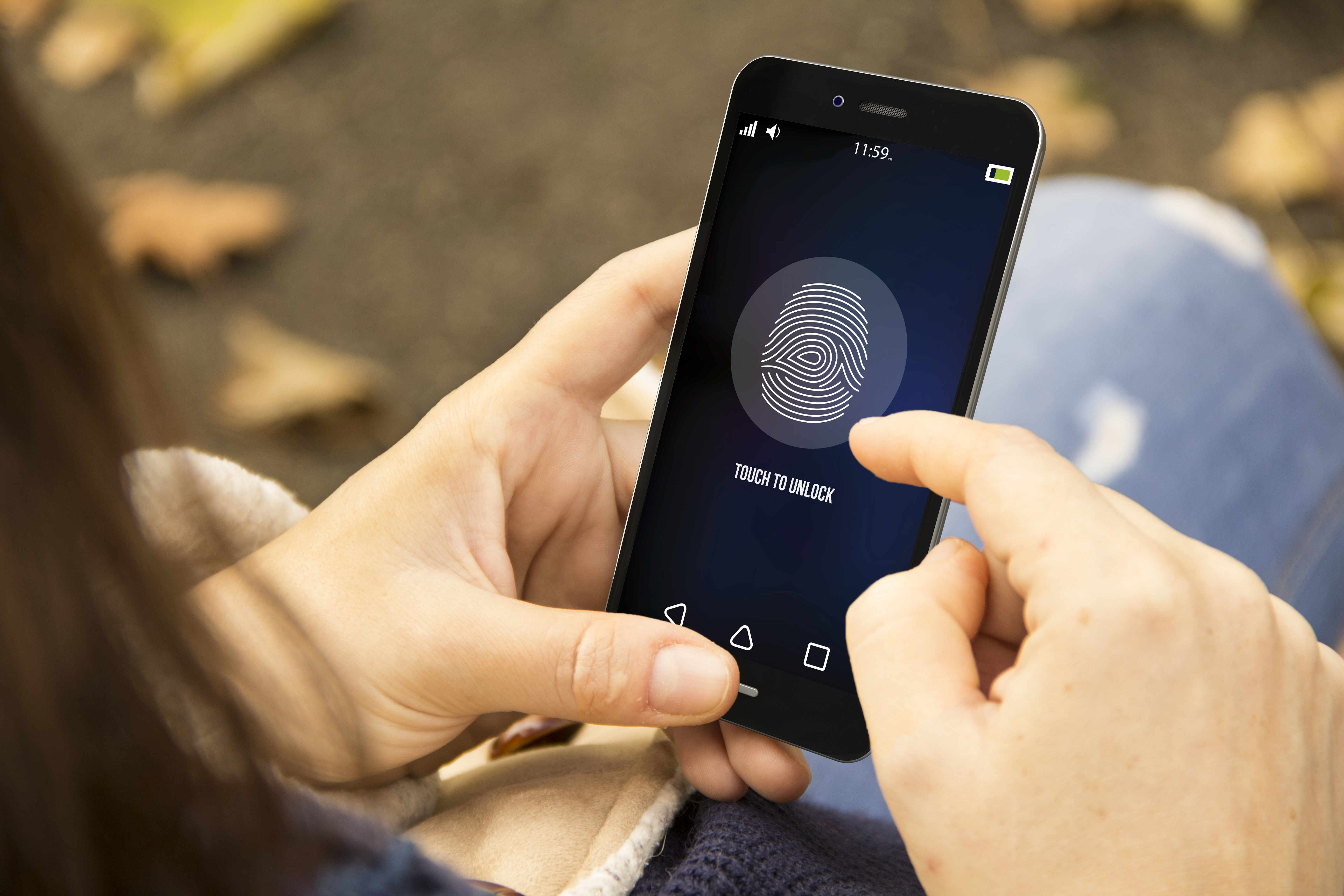 woman unlocking phone in the park