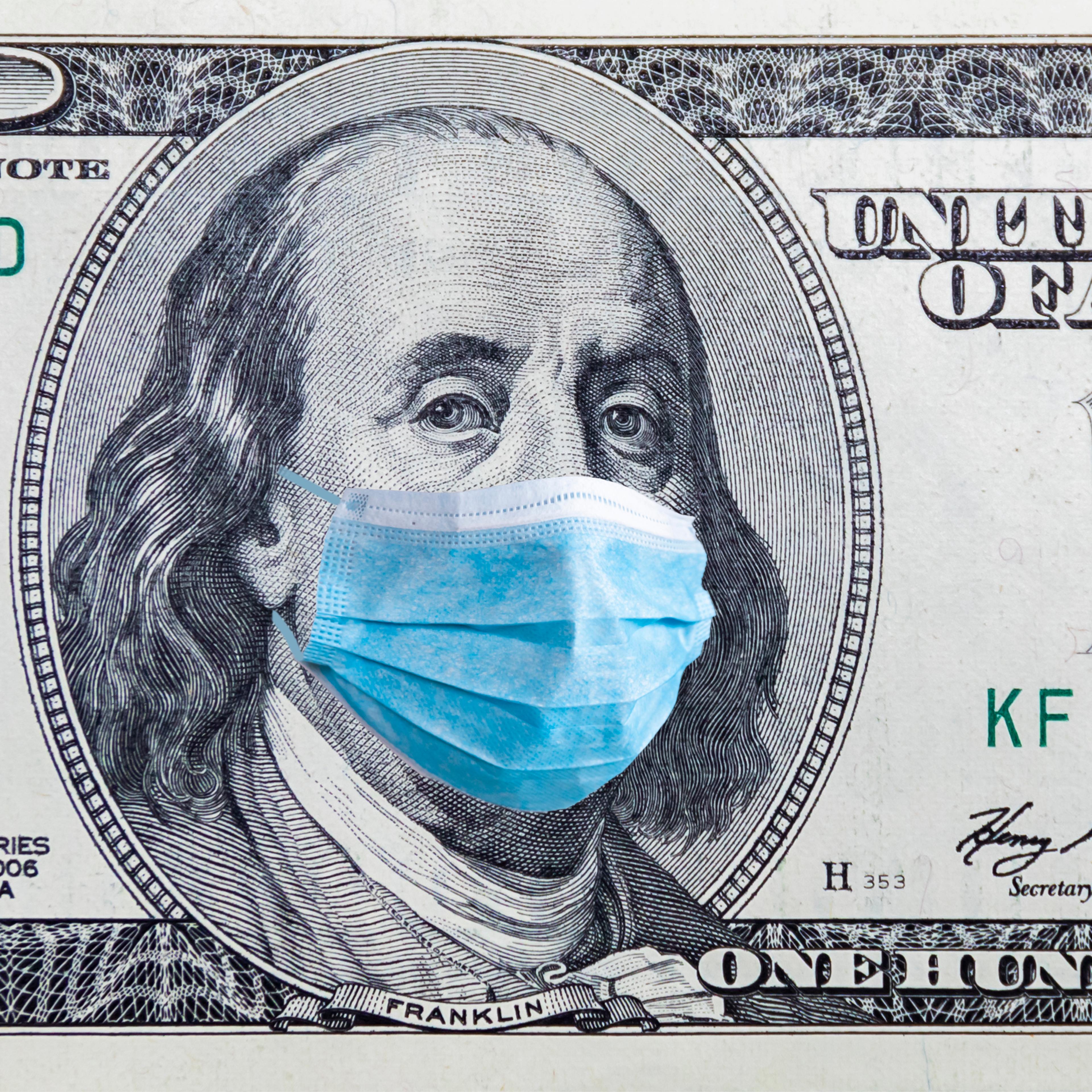 US quarantine, 100 dollar banknote with medical mask. The concept of epidemic and protection against coronavrius.