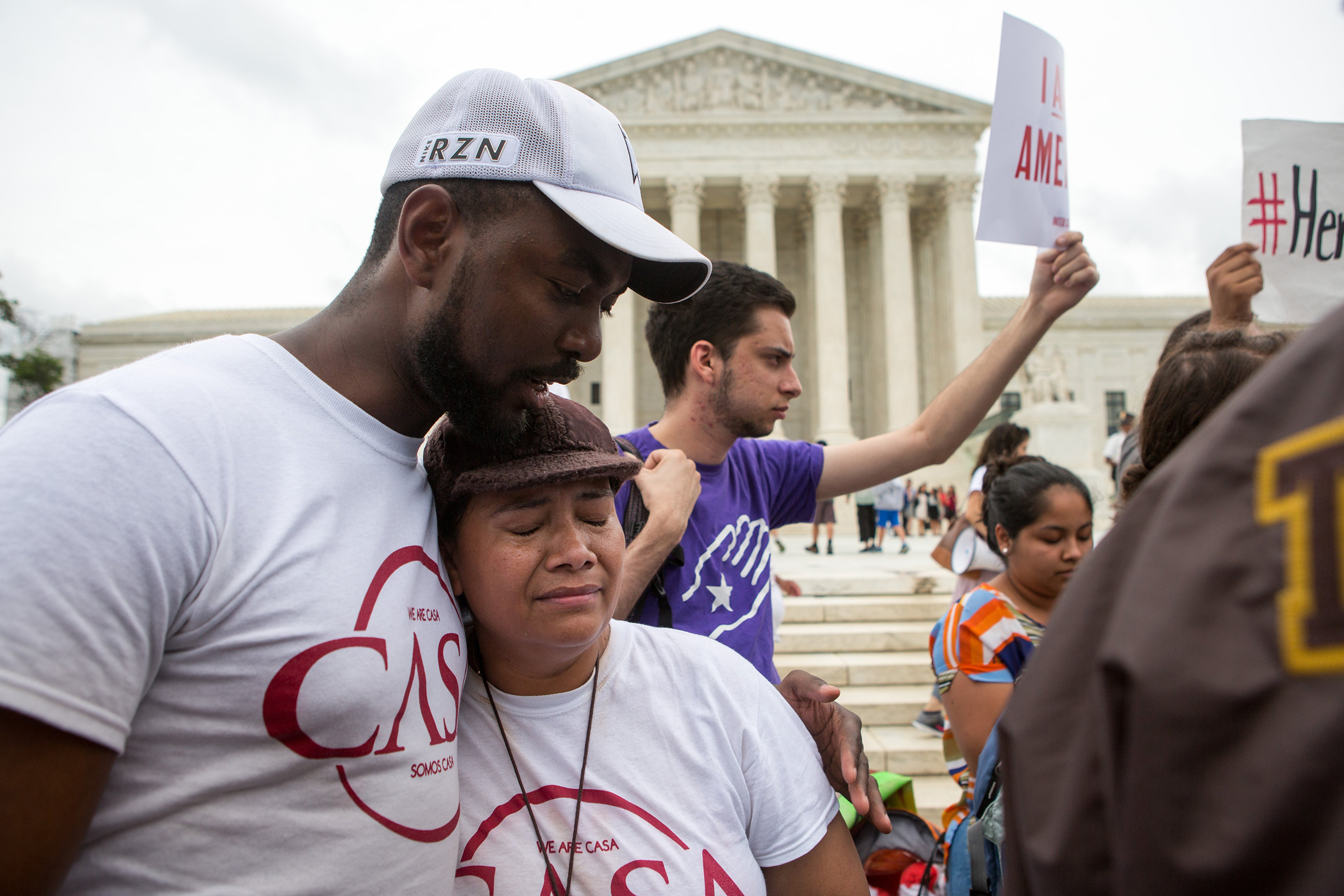Rosario Reyes, an undocumented mother from El Salvador, reacts to news on a Supreme Court decision blocking Obama's immigration plan, which would have protected millions of immigrants from deportation, in front of the U.S. Supreme Court in Washington, DC