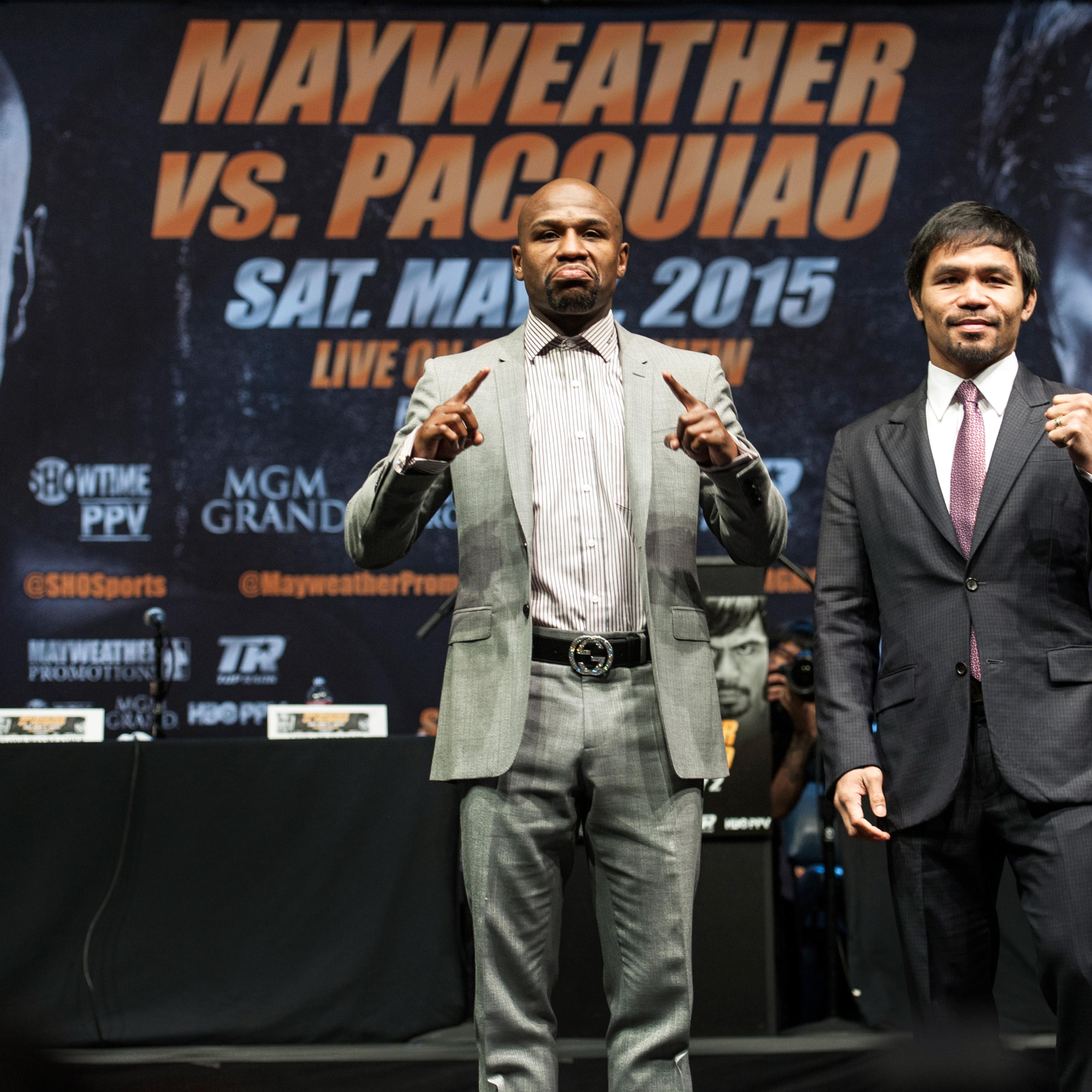 Floyd Mayweather Jr., and Manny Pacquiao strike their pose after a news conference Wednesday, March 11, 2015, in Los Angeles. Mayweather and Pacquiao are scheduled to fight on May 2 in Las Vegas.