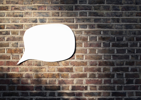 white-word-bubble-brick-wall