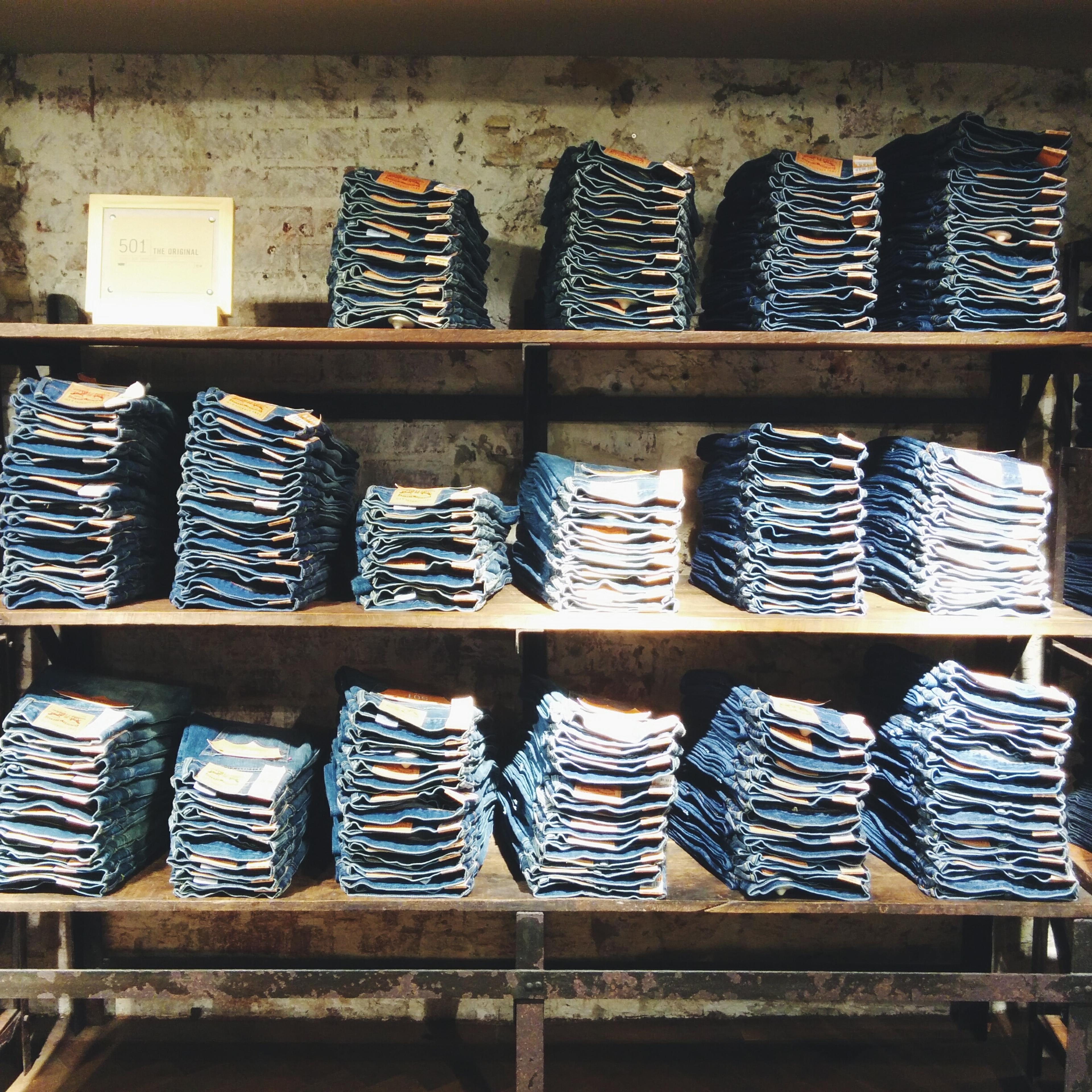 Folded Jeans Kept On Shelves In Shop