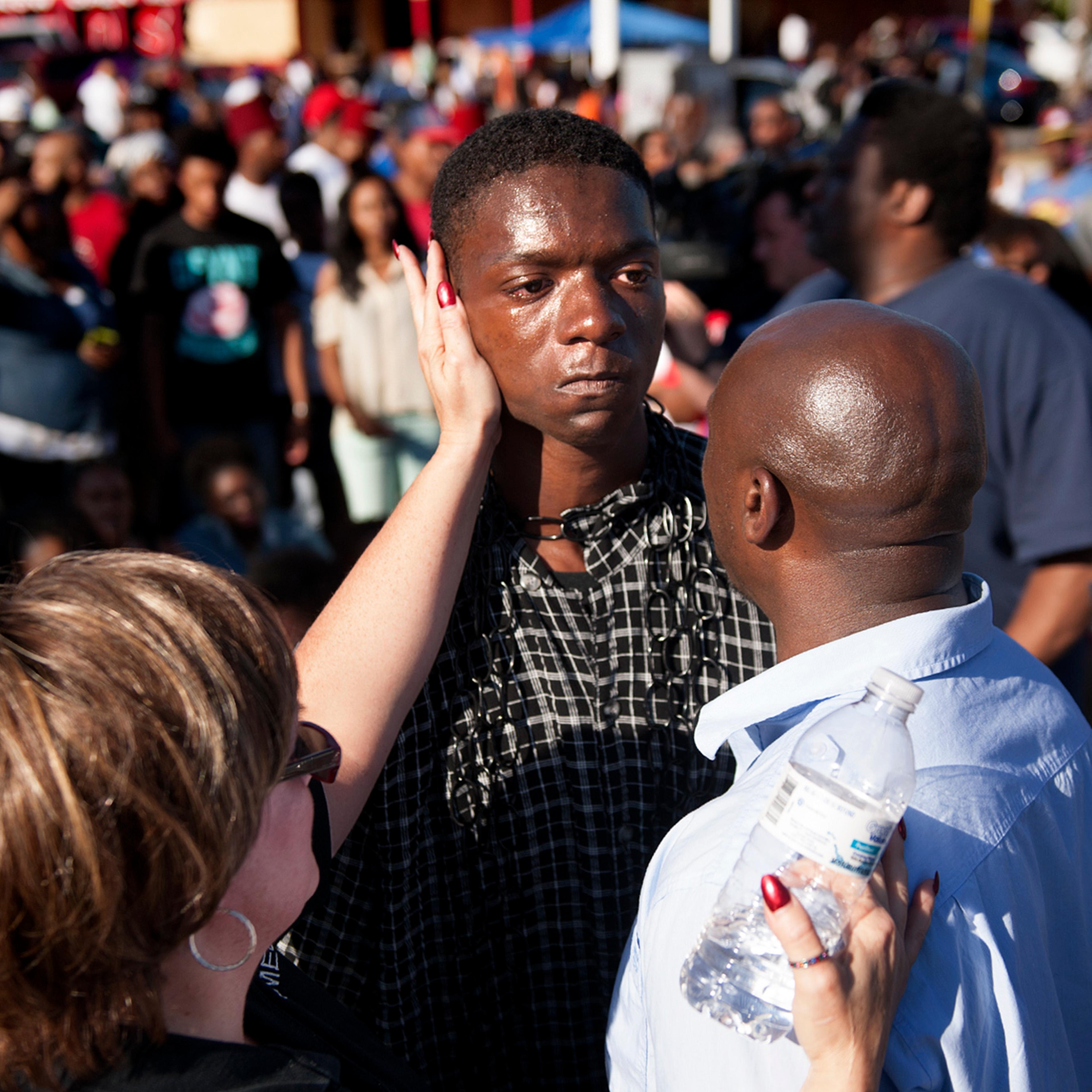 The Rev. Willis Johnson confronts 18-year-old Joshua Wilson as protesters defy police and block traffic on West Florissant Avenue at Canfield Drive in Ferguson, Mo. on Aug. 13, 2014.