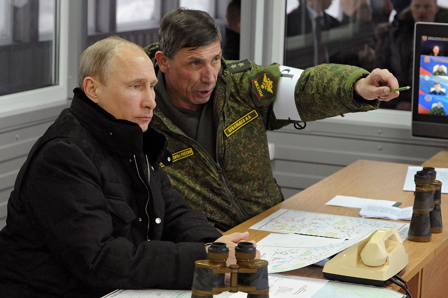 Russia's President Putin, Defence Minister Shoigu and head of Russian army's main department of combat preparation Buvaltsev watch military exercises at Kirillovsky firing ground in Leningrad region