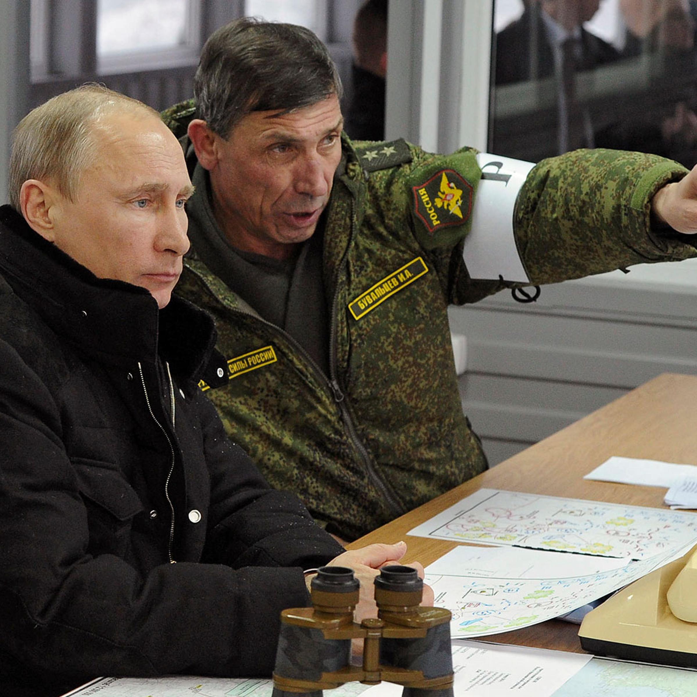 Russia's President Putin, Defence Minister Shoigu and head of Russian army's main department of combat preparation Buvaltsev watch military exercises at Kirillovsky firing ground in Leningrad region