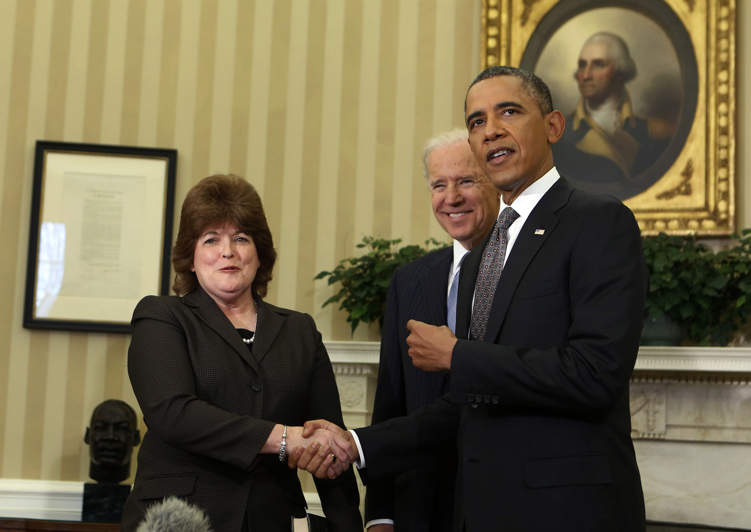 U.S. President Obama shakes hands with U.S. Secret Service agent Pierson after she is sworn in as first woman Director of the Secret Service in the Oval Office of the White House in Washington