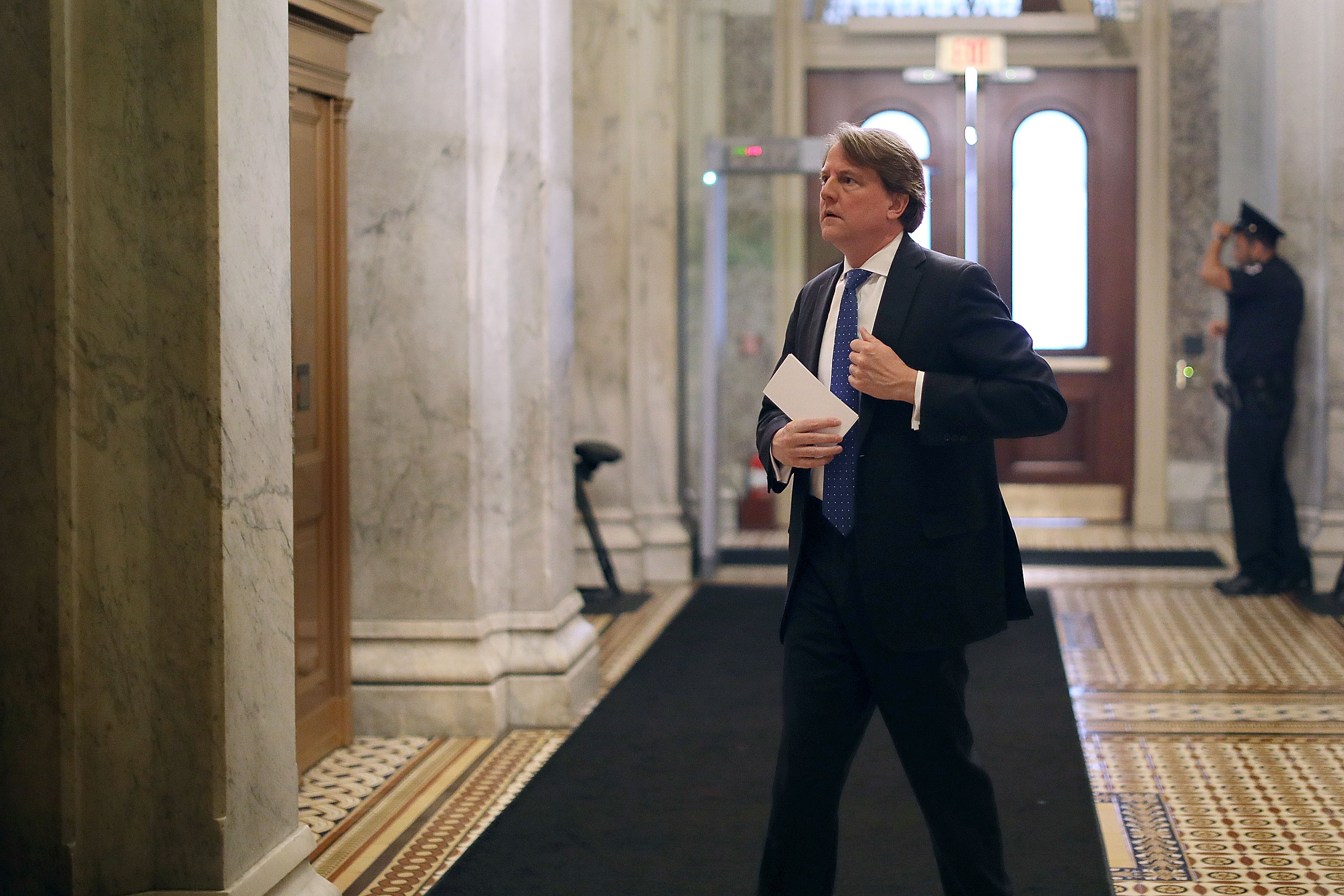 McGahn putting an envelope in his jacket