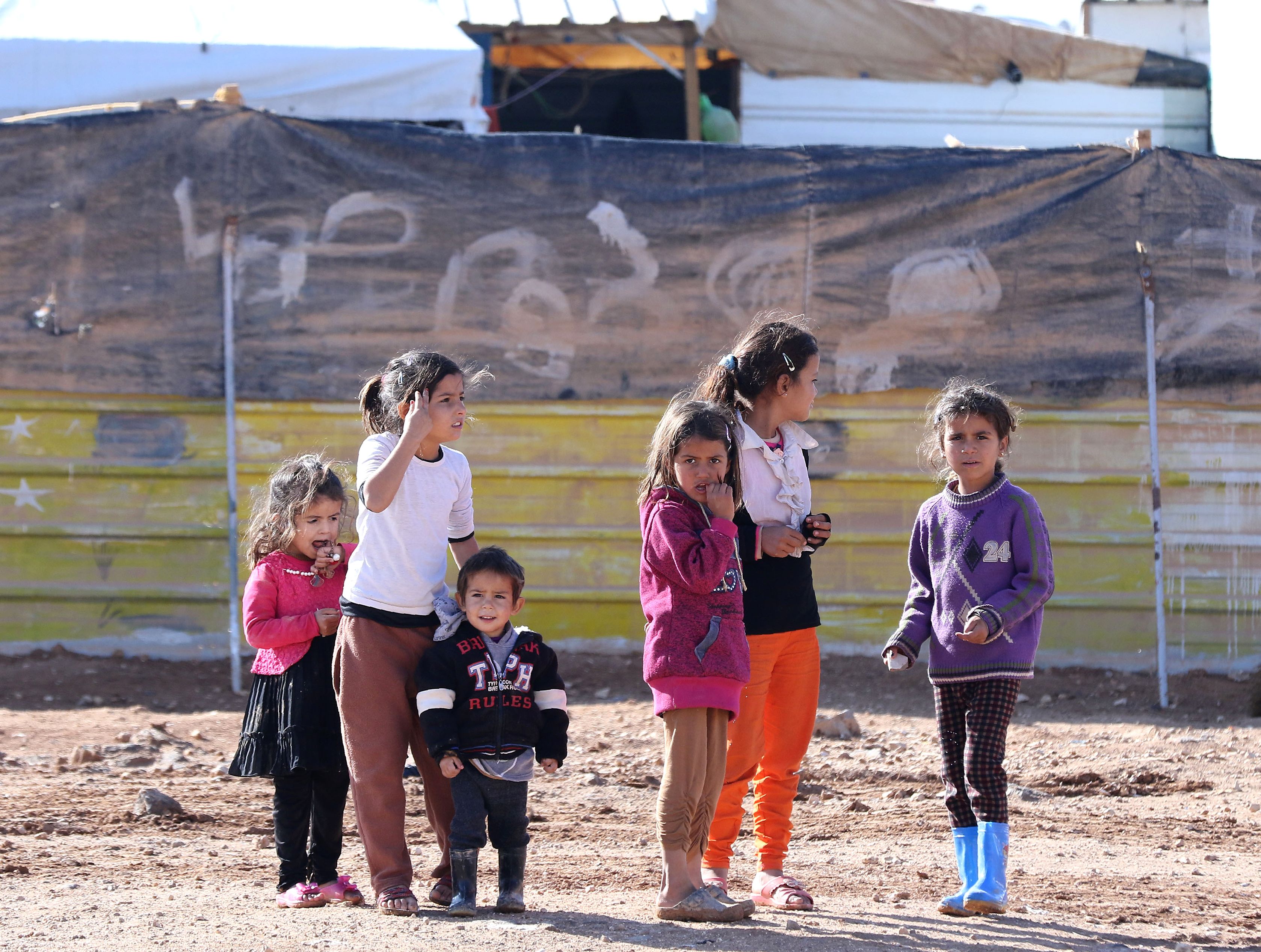 Syrian children play at the Zaatari refugee camp, located close to the northern Jordanian city of Mafraq near the border with Syria, on Dec. 3, 2016.