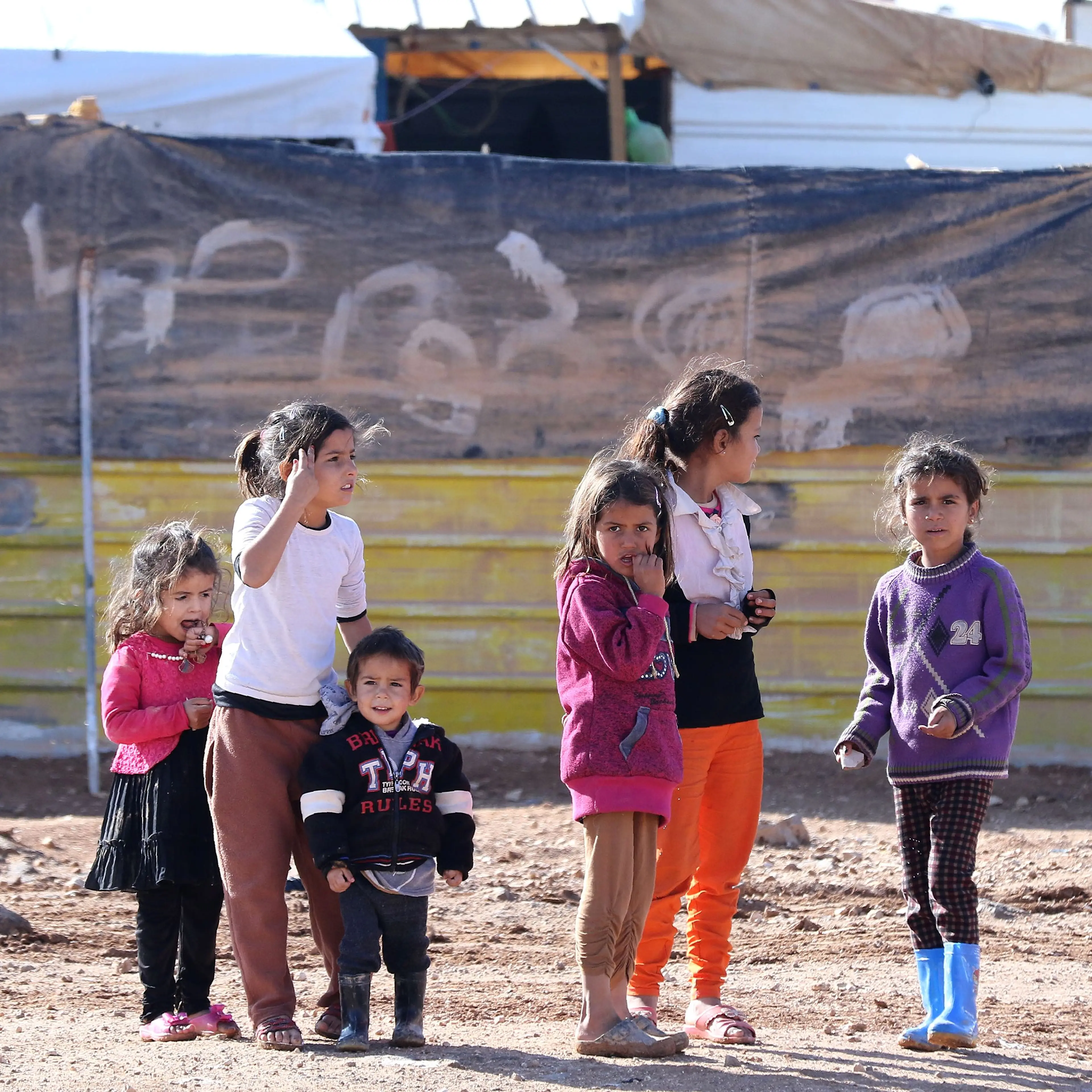 Syrian children play at the Zaatari refugee camp, located close to the northern Jordanian city of Mafraq near the border with Syria, on Dec. 3, 2016.