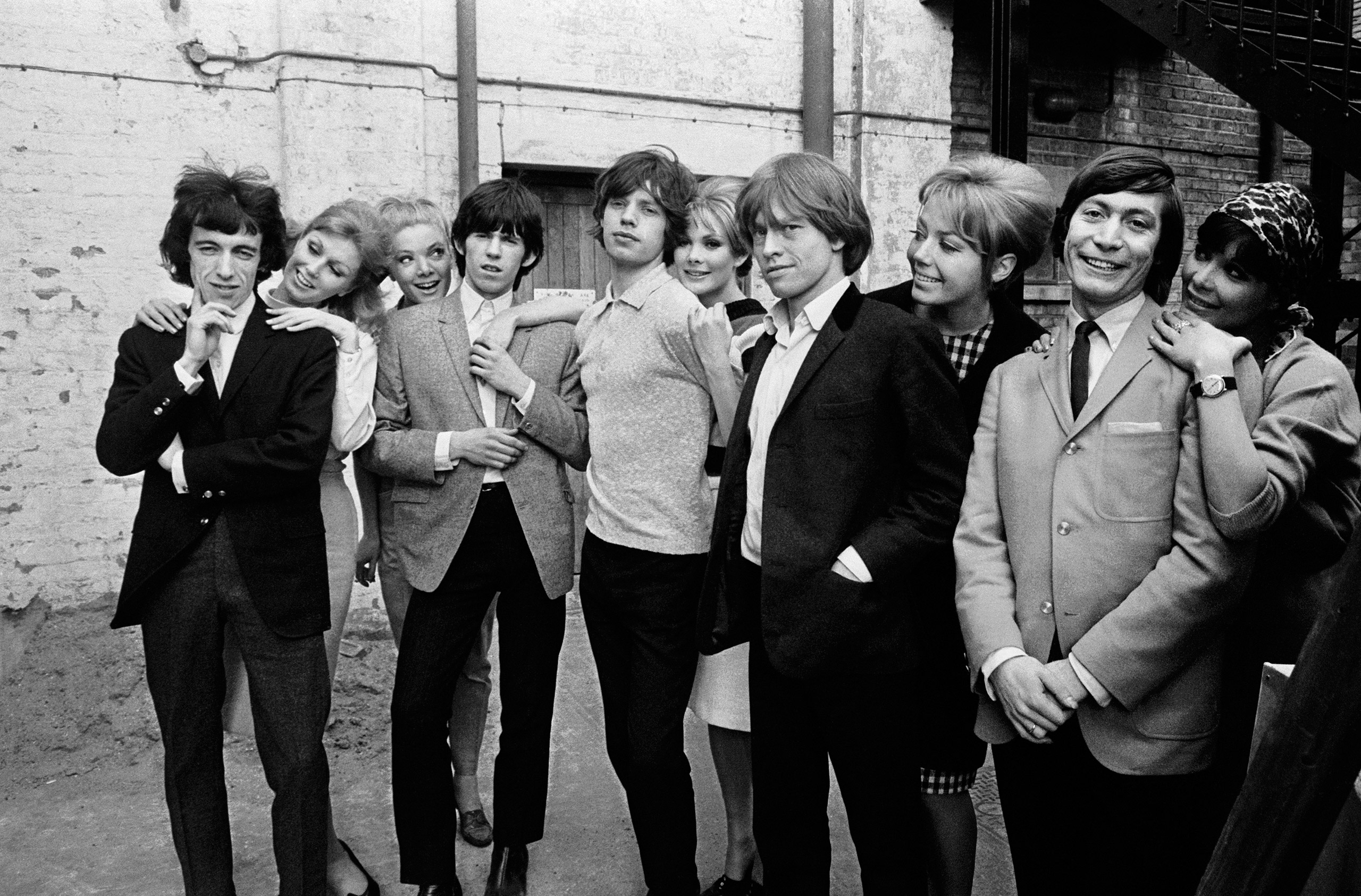 The Rolling Stones posing with a group of women during rehearsals for ABC's 'Thank Your Lucky Stars' TV pop music show at Teddington Studios, London, November 11, 1964. From left to right, Bill Wyman, Keith Richards, Mick Jagger, Brian Jones and Charlie 