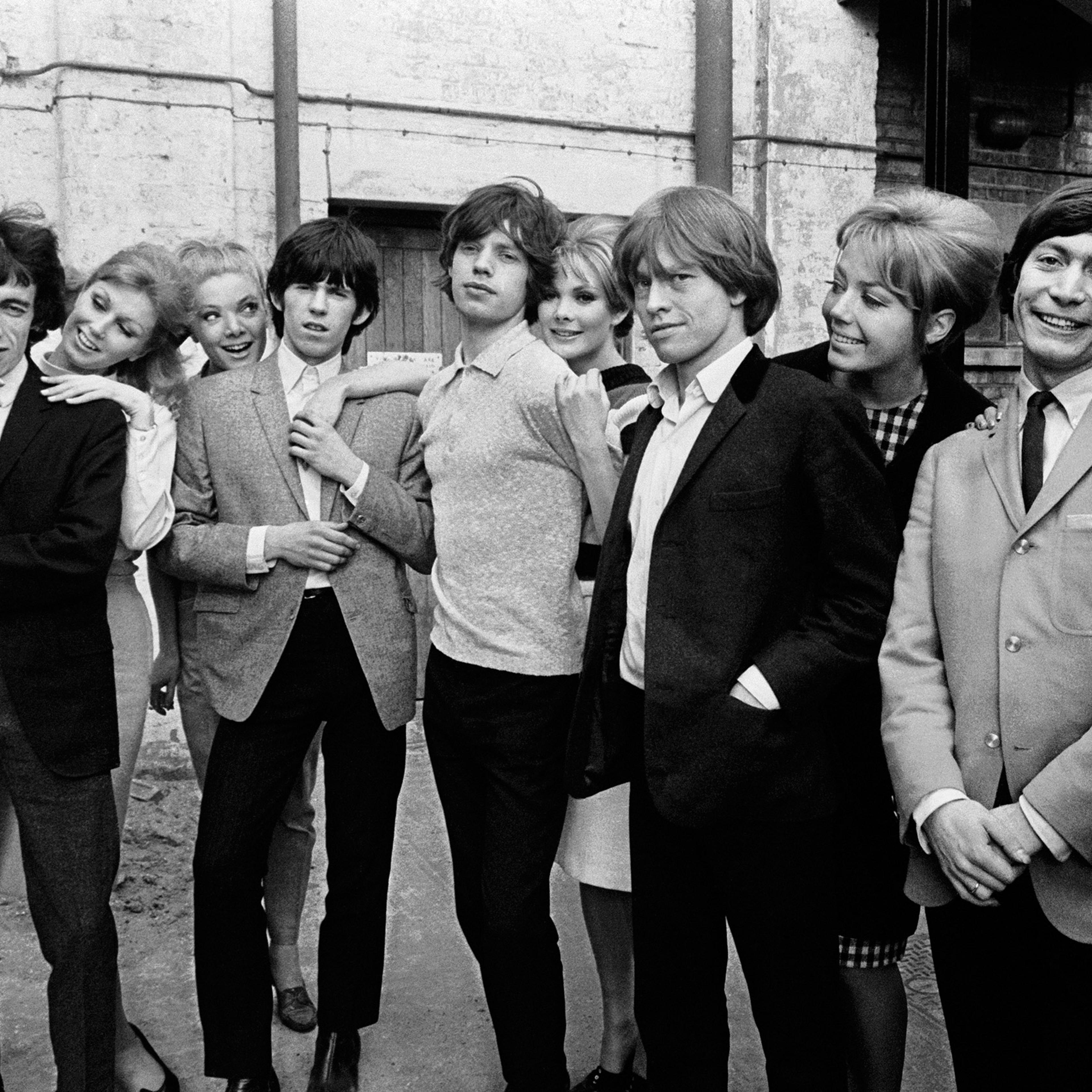 The Rolling Stones posing with a group of women during rehearsals for ABC's 'Thank Your Lucky Stars' TV pop music show at Teddington Studios, London, November 11, 1964. From left to right, Bill Wyman, Keith Richards, Mick Jagger, Brian Jones and Charlie