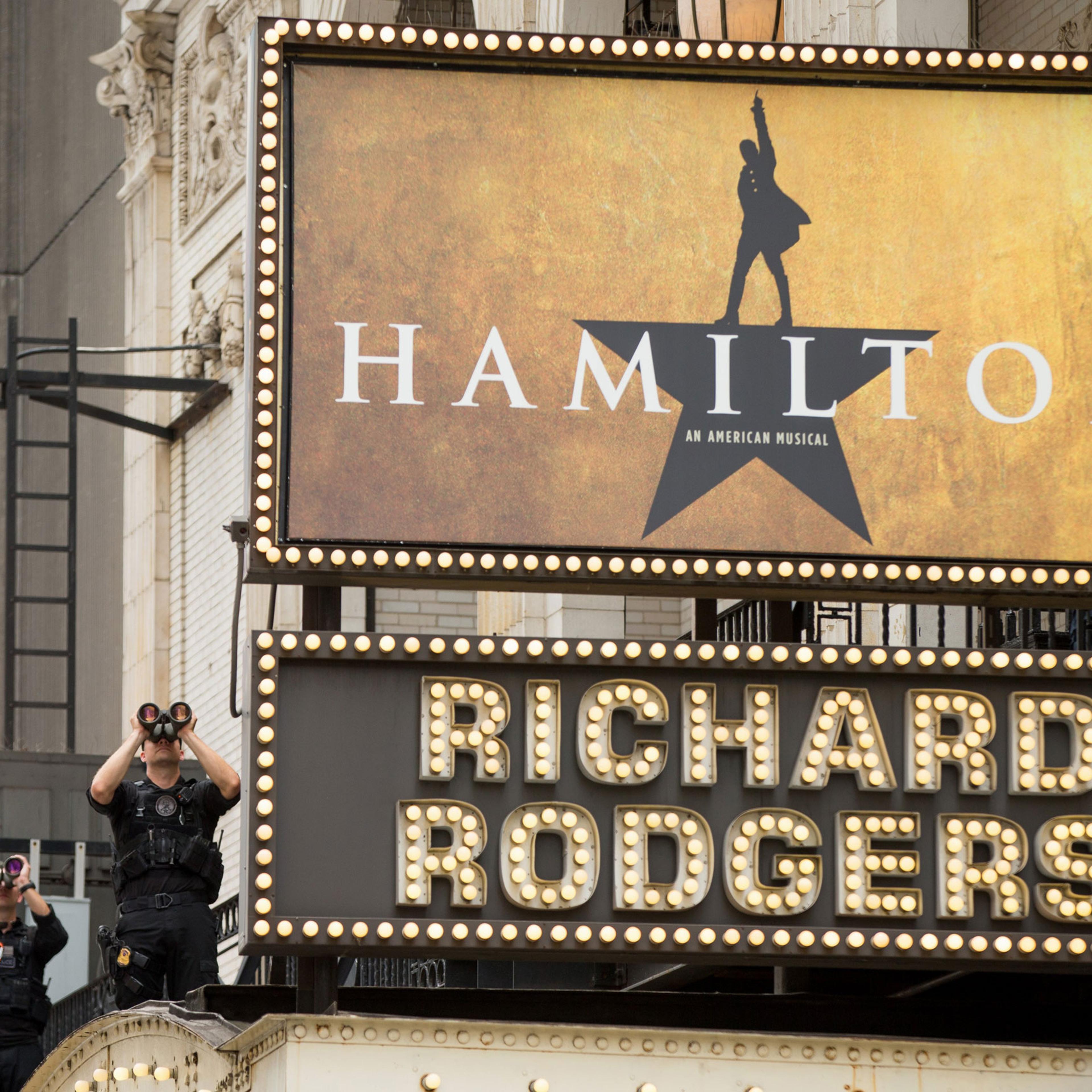 Secret Service officers stand on the awning of the Richard Rodgers Theatre in New York, Saturday, July 18, 2015, as President Barack Obama, daughters Sasha and Malia, his sister Maya Soetoro-Ng, her husband Konrad Ng, and friends attend a performance of