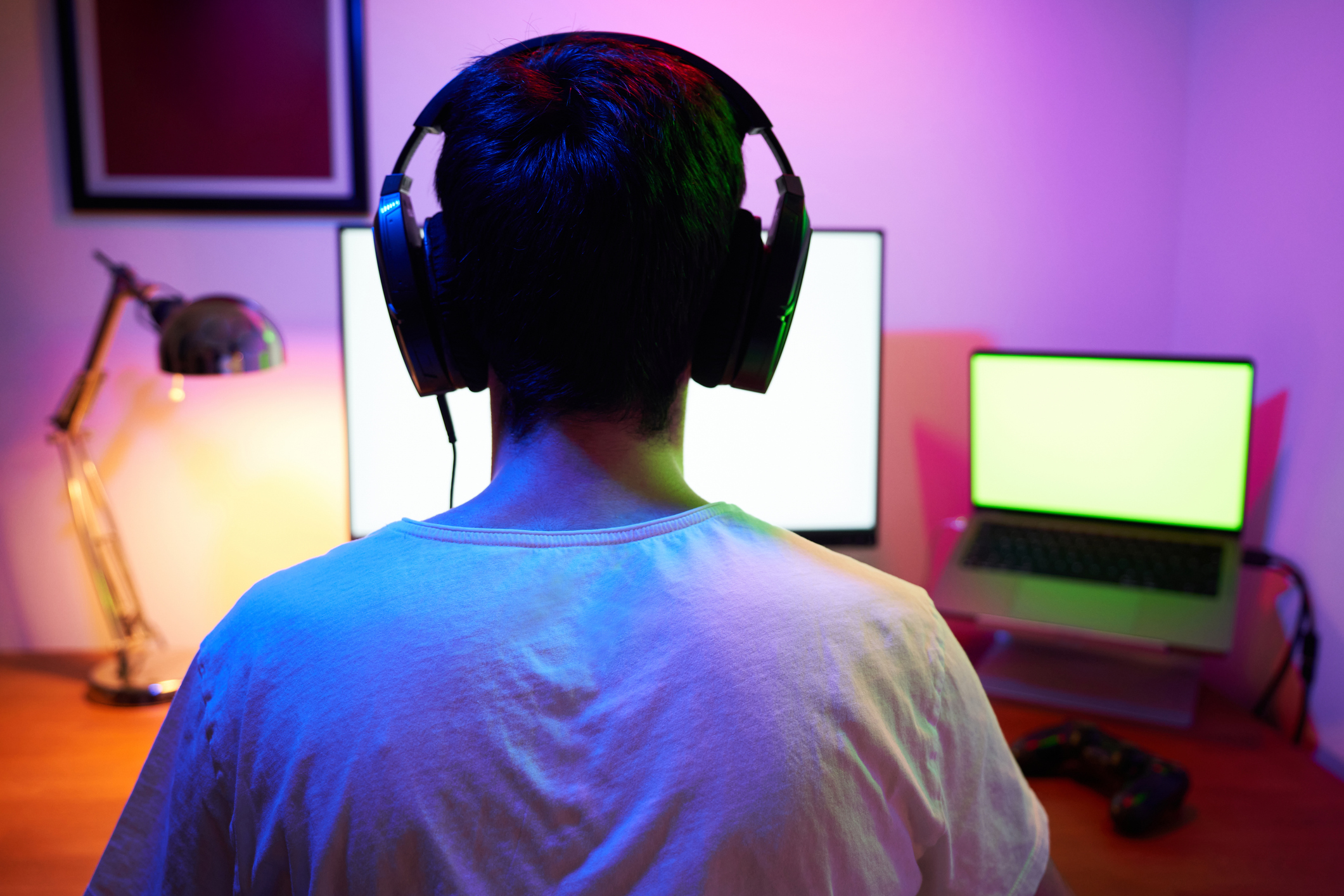 Young man wearing headset and play computer video games online