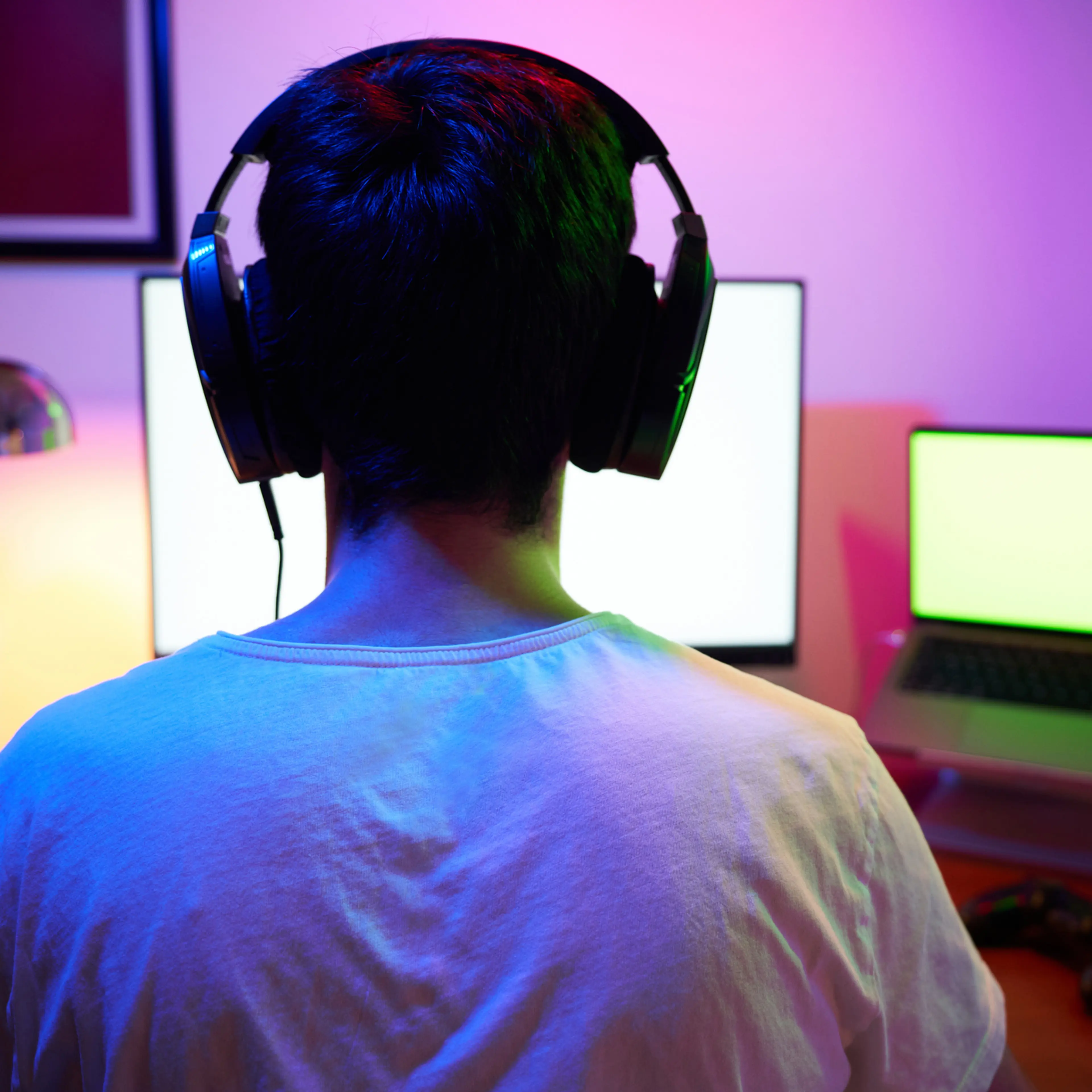 Young man wearing headset and play computer video games online