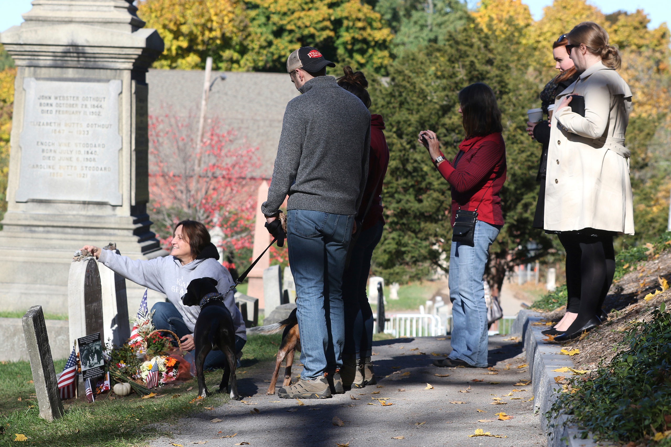 People gather at the grave of women's suffragist leader Susan B. Anthony in Mt. Hope Cemetery in Rochester, NY Monday, Nov. 7, 2016, in anticipation of the election. The cemetery will extend its hours on Election Day to give people more time to visit her