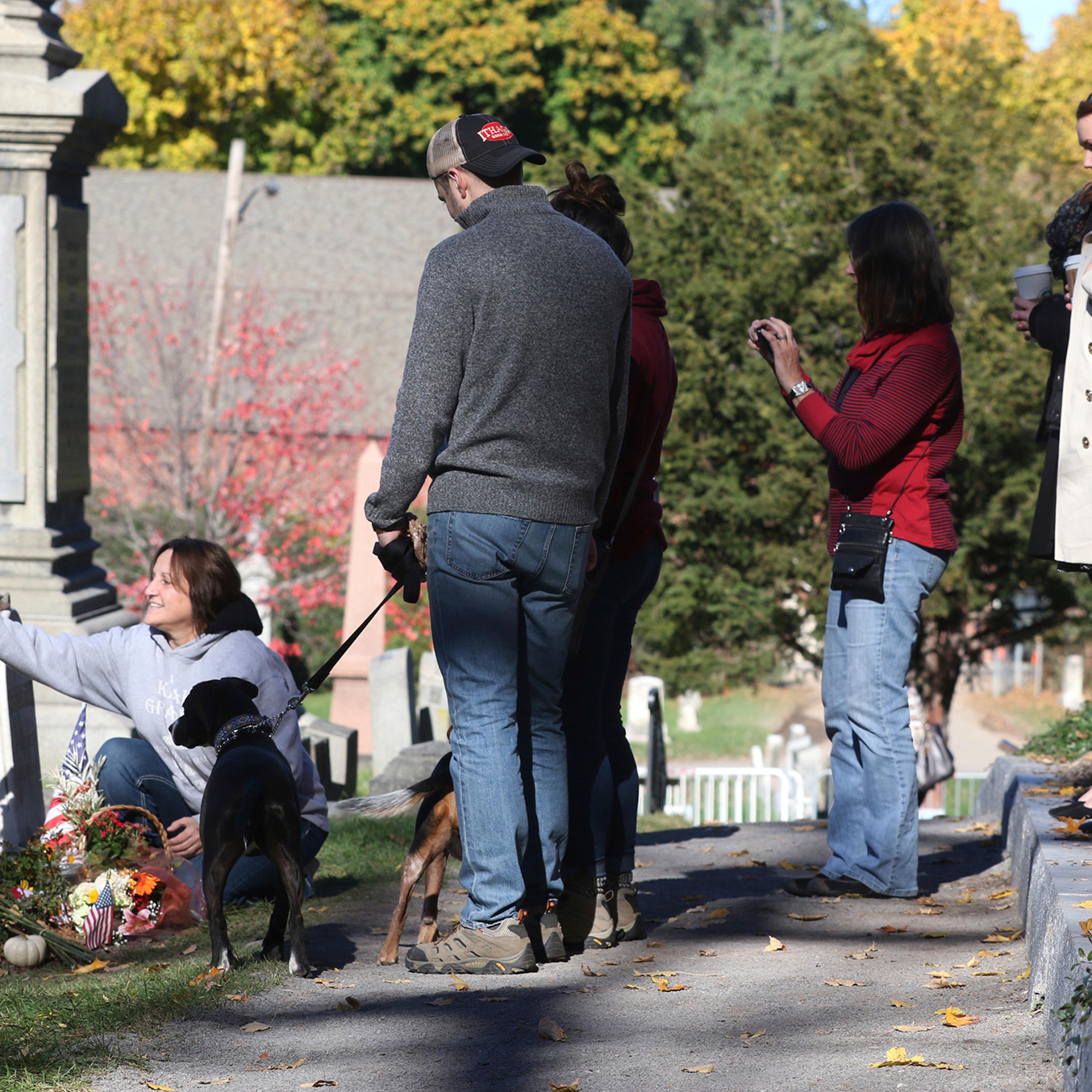 People gather at the grave of women's suffragist leader Susan B. Anthony in Mt. Hope Cemetery in Rochester, NY Monday, Nov. 7, 2016, in anticipation of the election. The cemetery will extend its hours on Election Day to give people more time to visit her