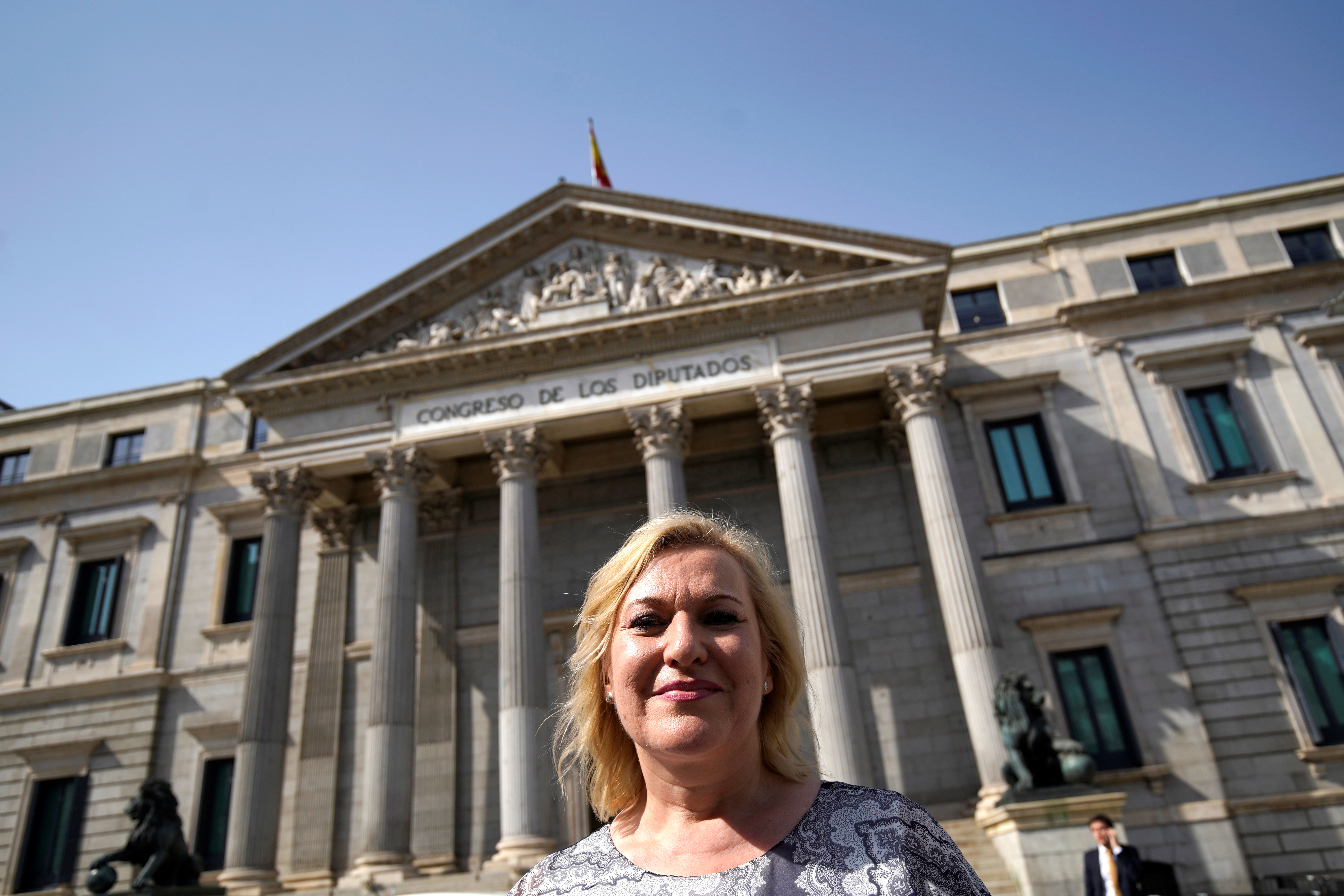 Ines Madrigal, who alleges she was one of Spain's "stolen babies" and has taken former doctor Eduardo Vela to court for falsifying her birth certificate to give her to her adoptive mother, poses outside Parliament building in Madrid